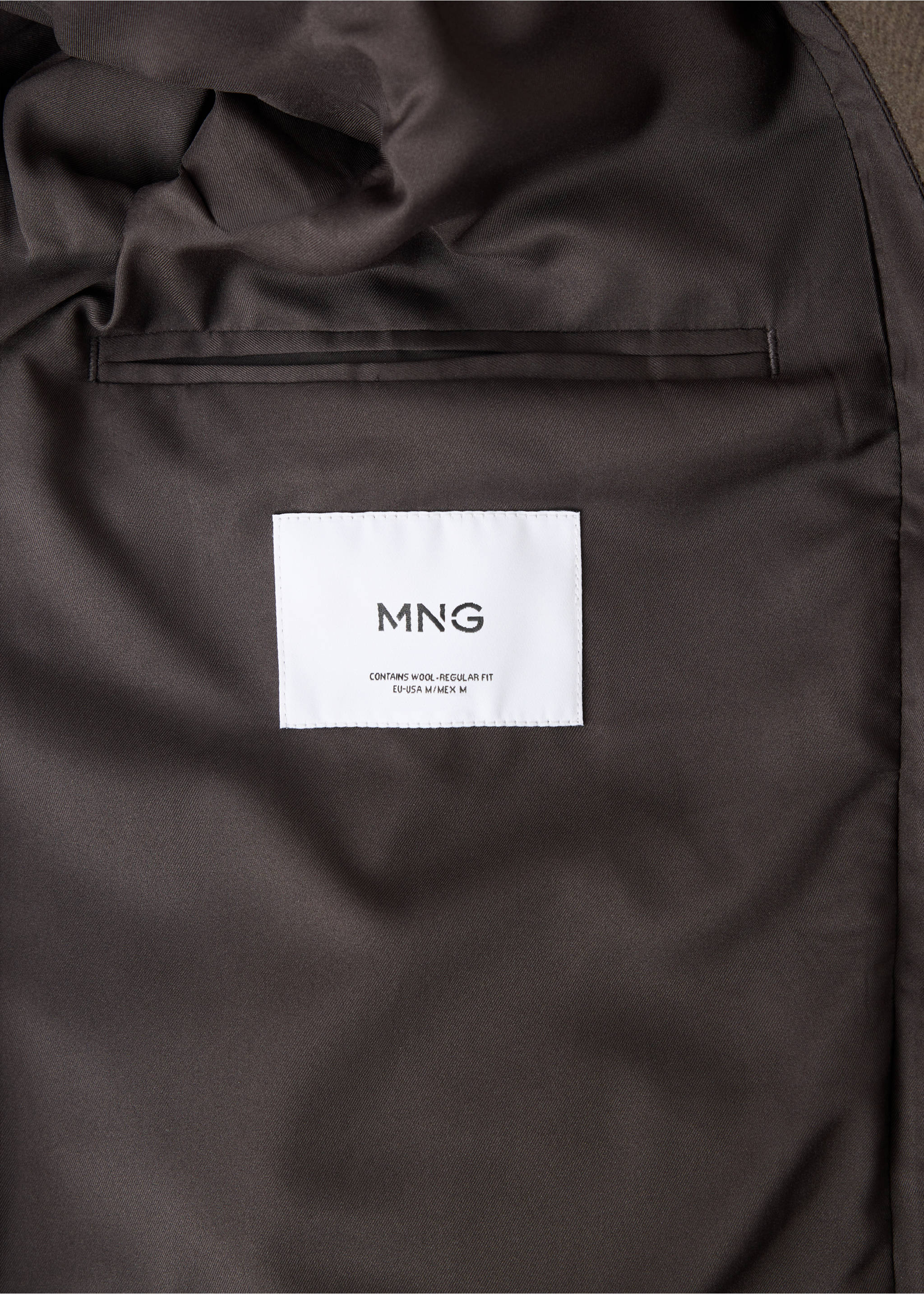 Coat interior detail showing the lining, welt pocket, and MNG brand label., Medium Brown. Ref: 37057888-00.