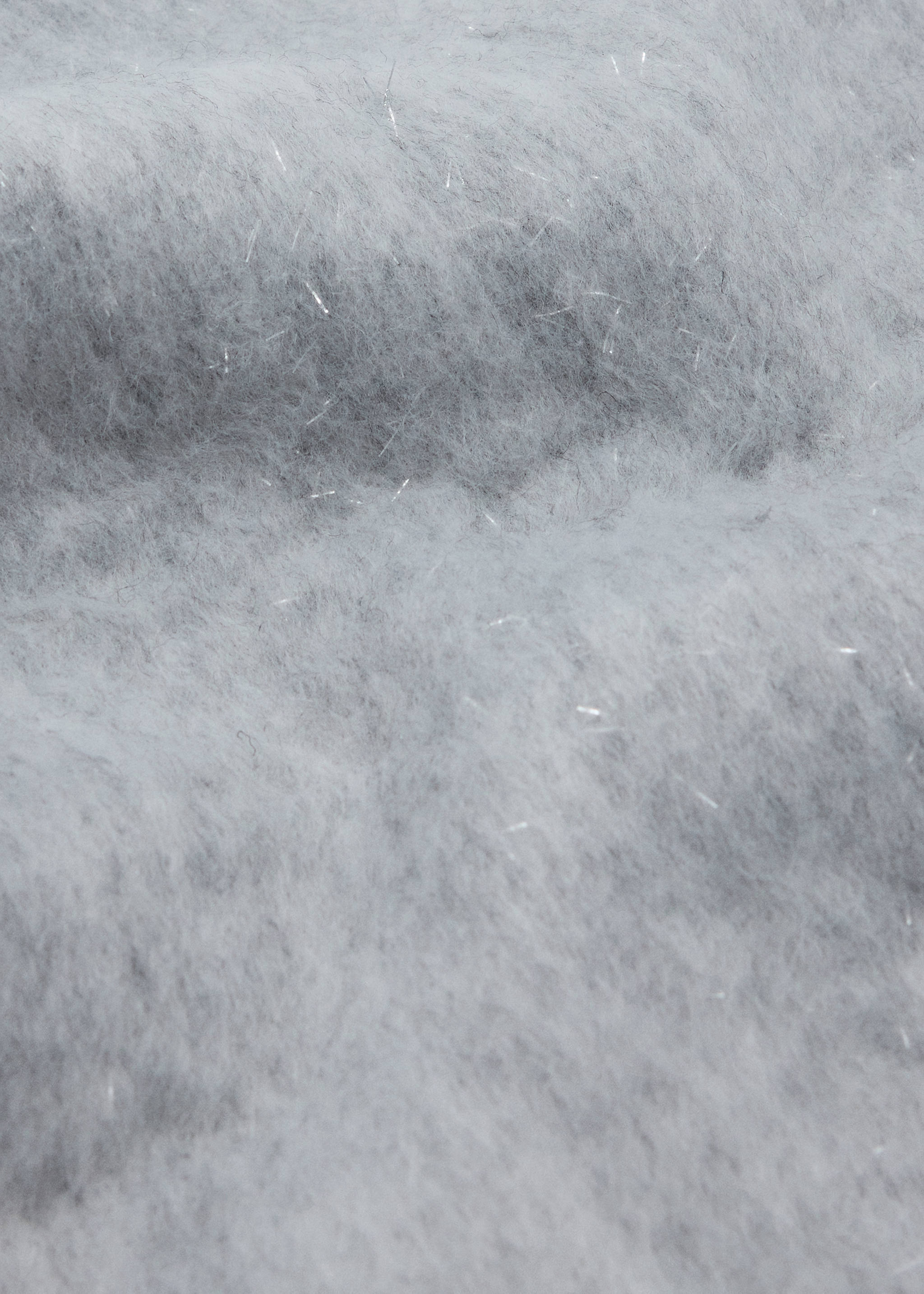 Close-up of a soft grey scarf with metallic silver threads.