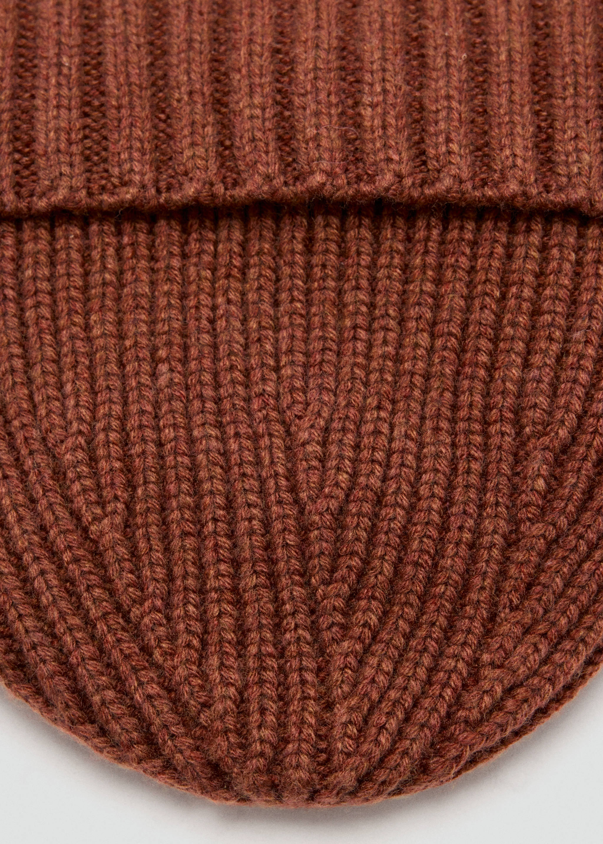 Brown rib-knit beanie accessory, close-up view.
