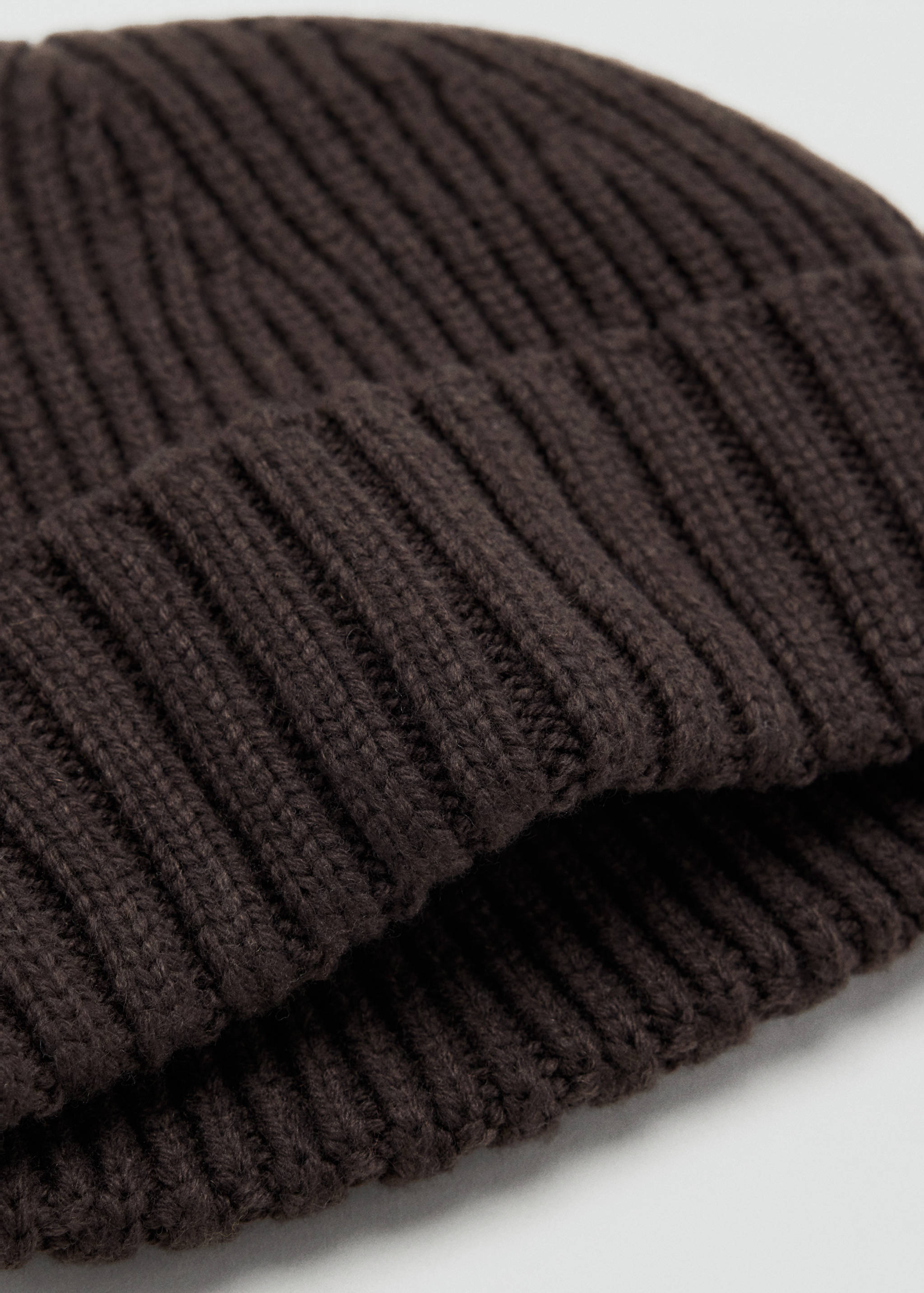 Dark brown ribbed knit beanie with a folded cuff.