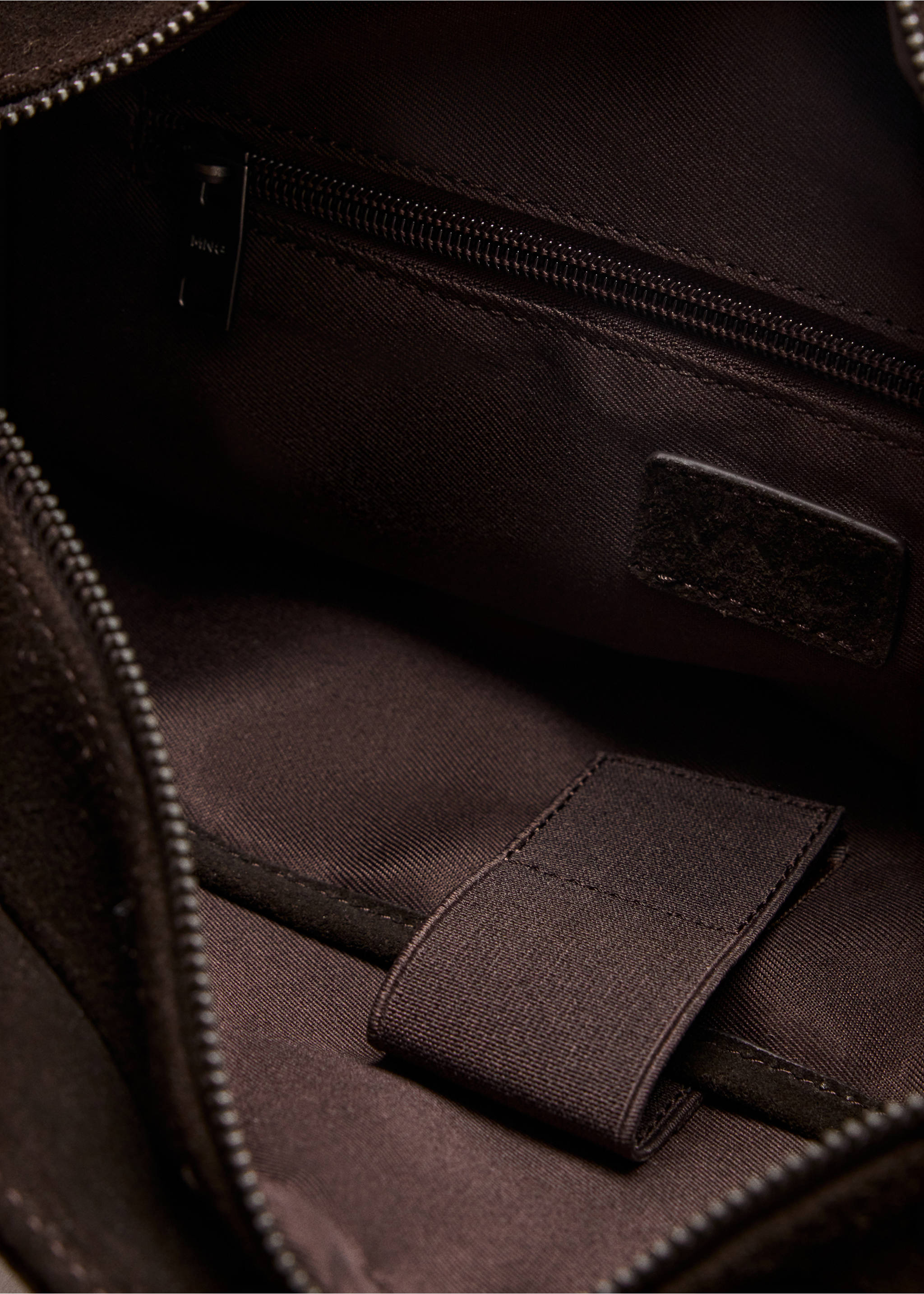 Close-up of the dark brown bowling bag interior showing lining and zip pocket., Brown. Ref: 37057903-00.