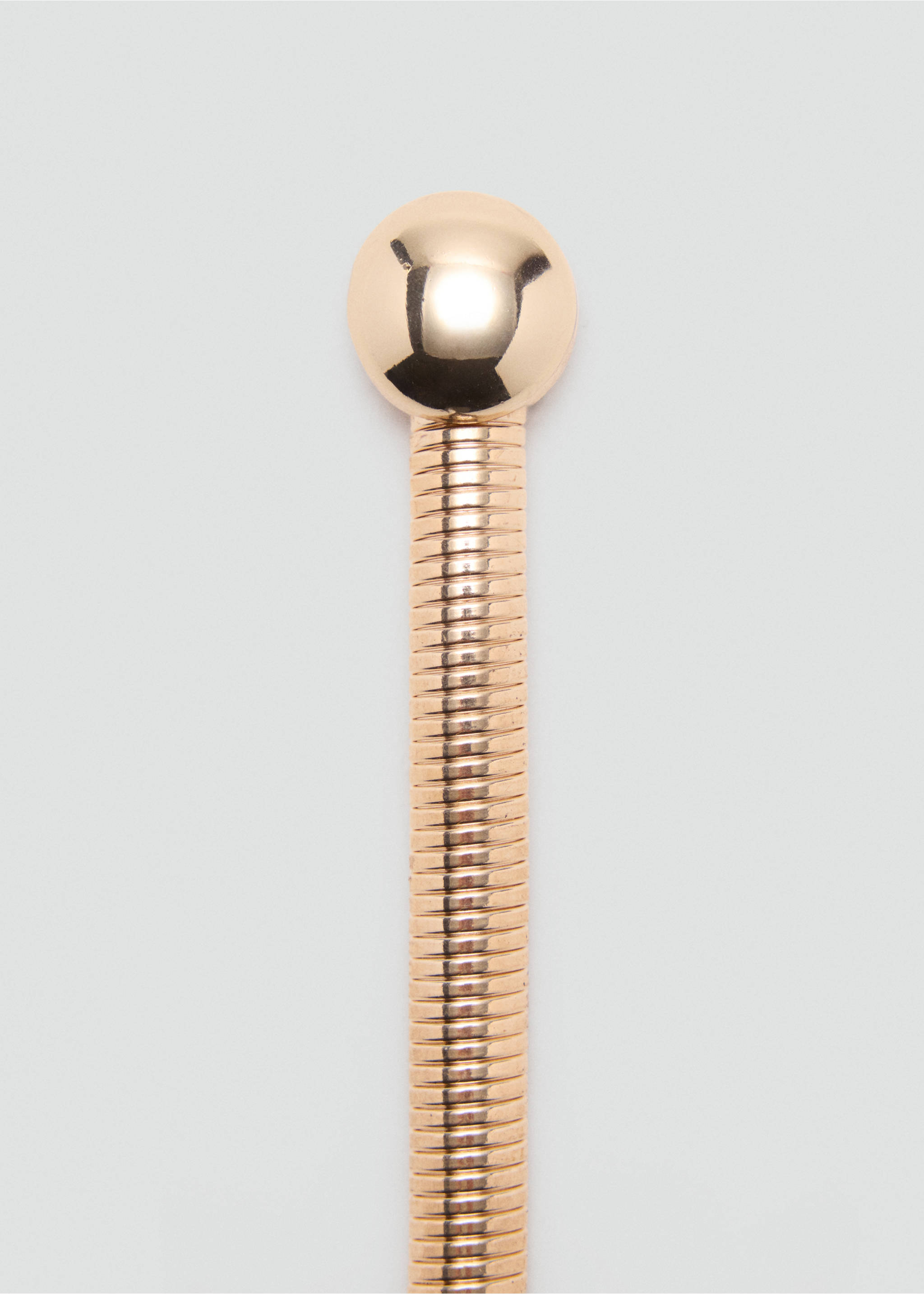 Close-up of a gold metallic belt detail featuring a snake-chain band and spherical end., Gold. Ref: 37057905-00.