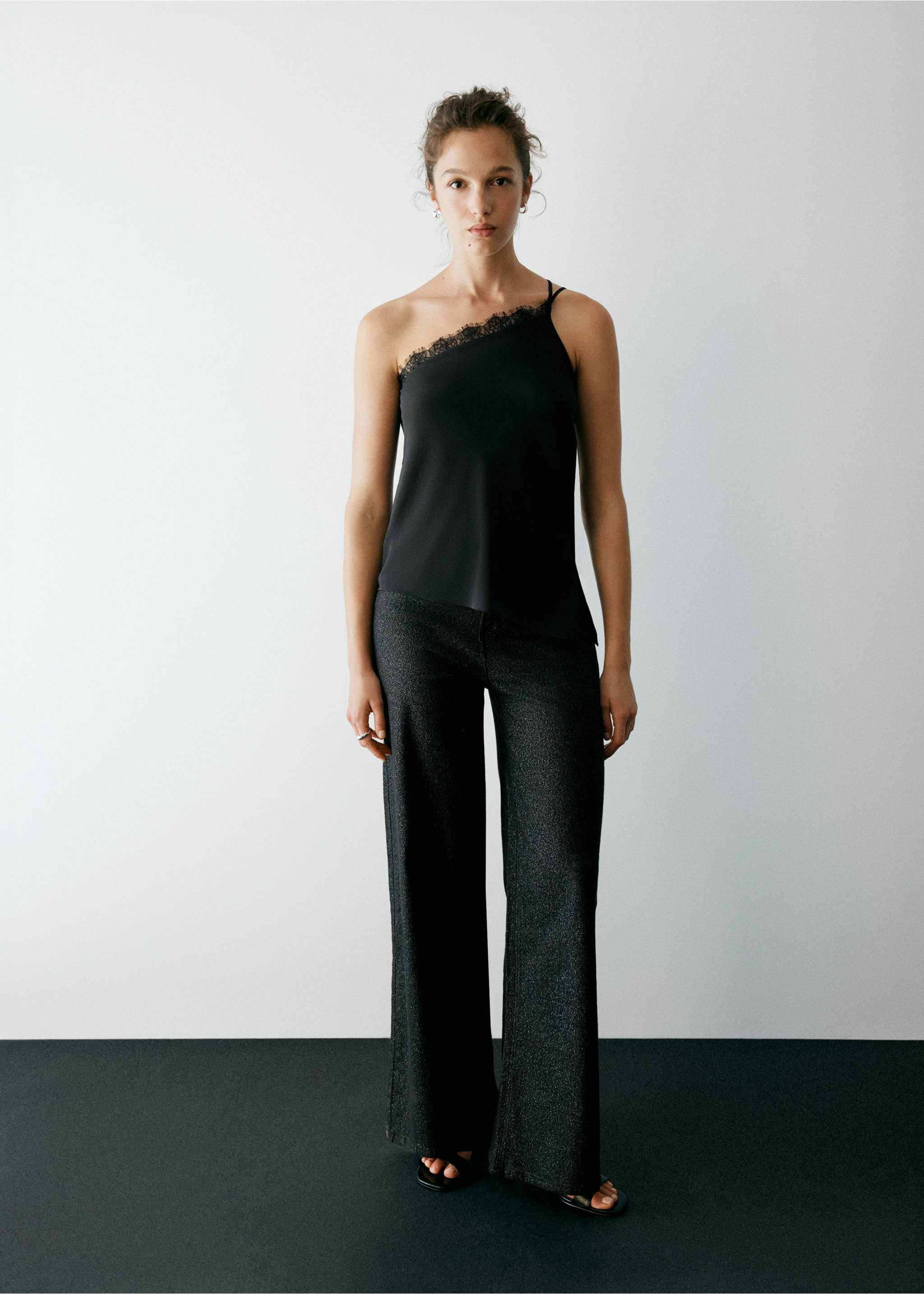 Black one-shoulder top with lace trim, worn with wide-leg trousers, Black. Ref: 37057910-00.
