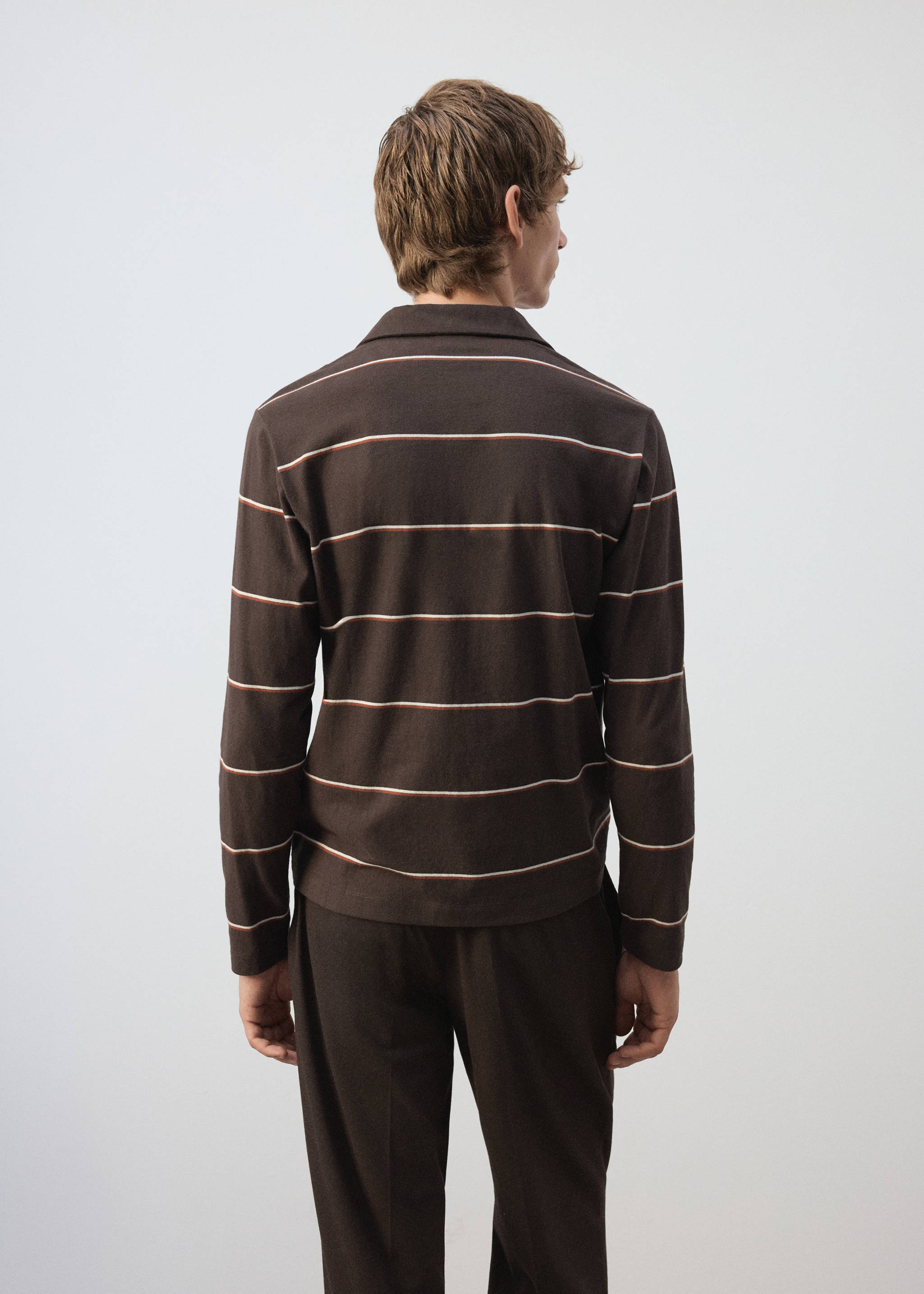 Brown long-sleeve polo shirt with white and orange stripes, back view.