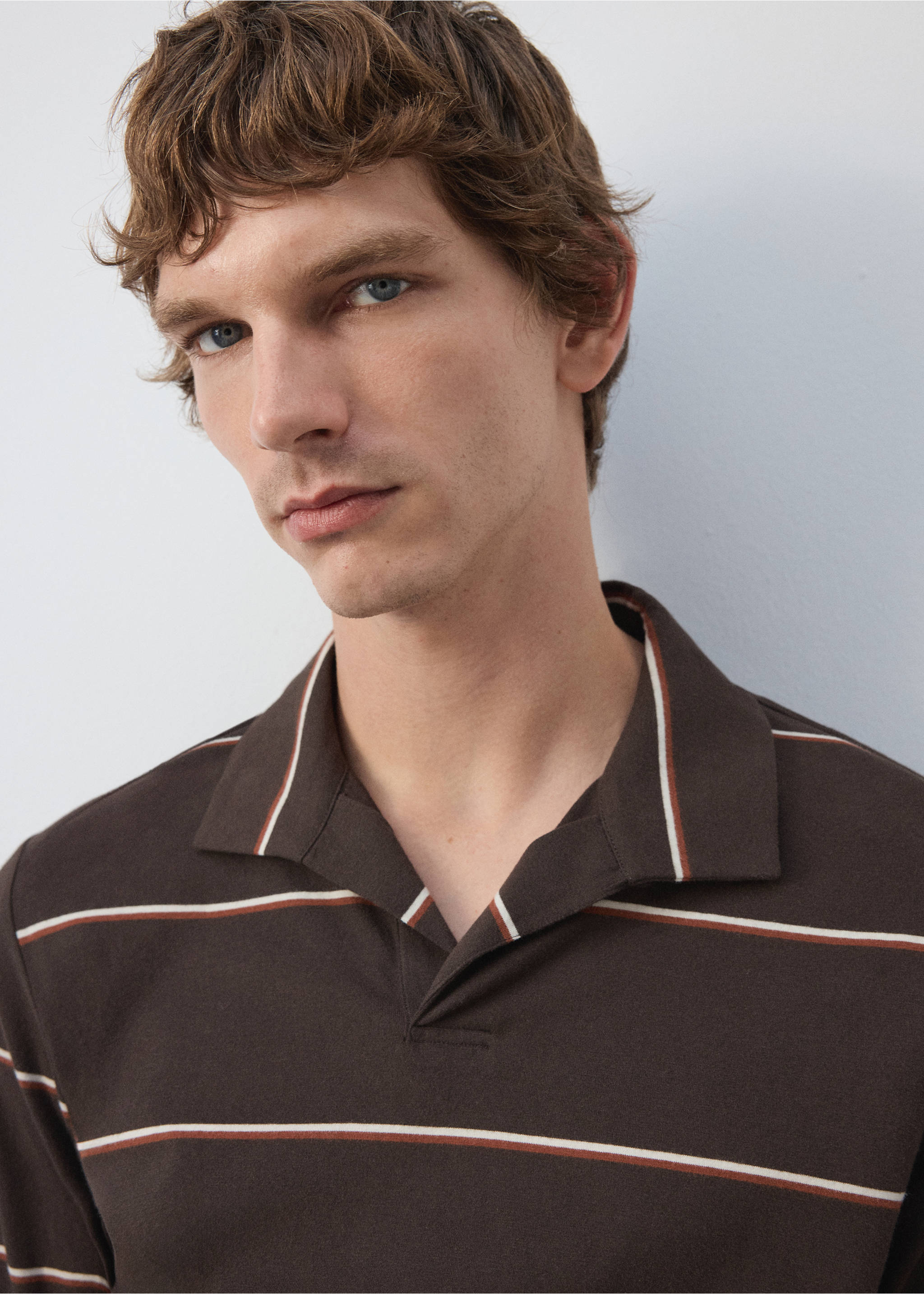Close-up of a brown polo shirt with white and orange stripes., Coffee. Ref: 37057912-00.