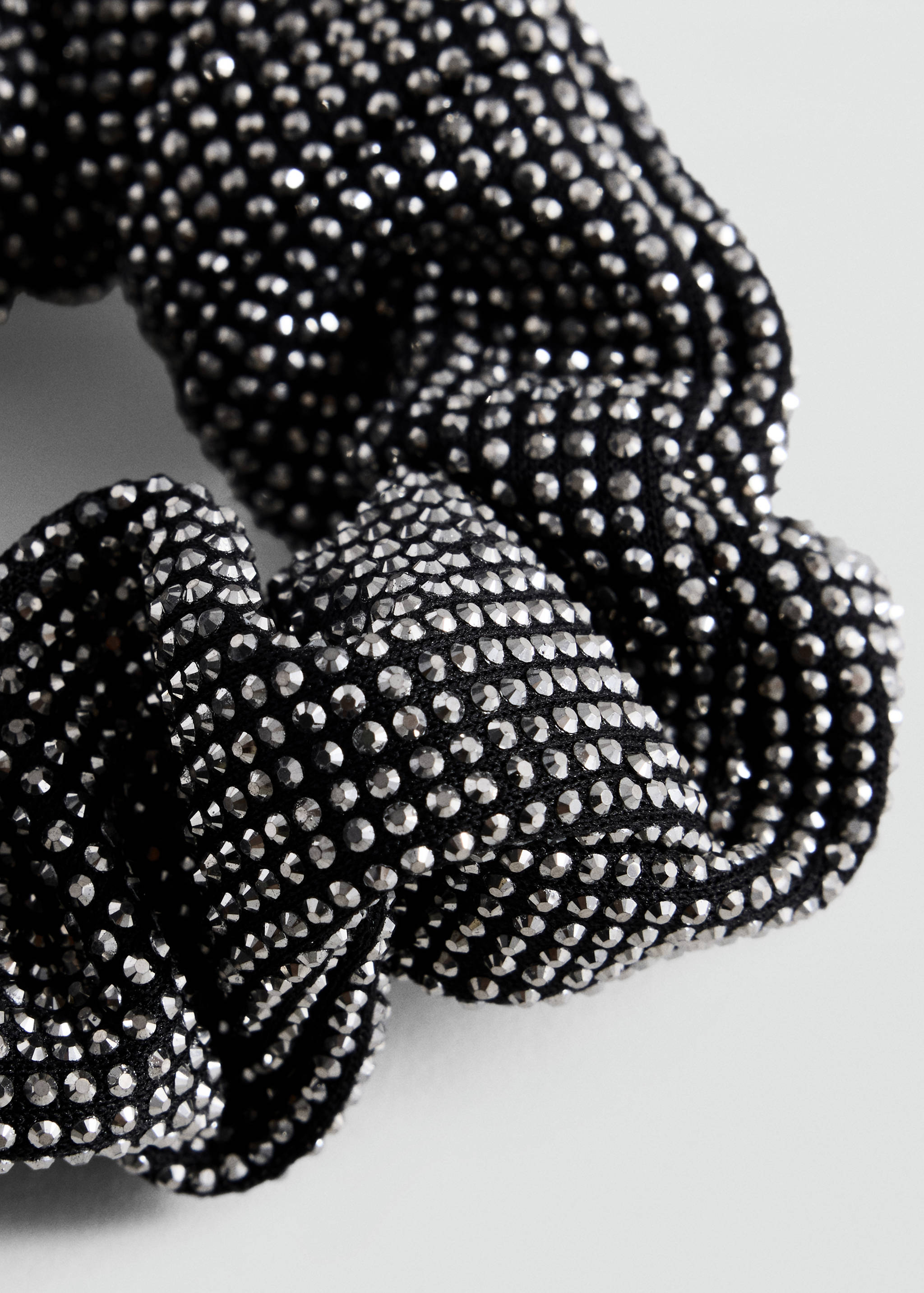 Black scrunchie with dense silver stud embellishment.