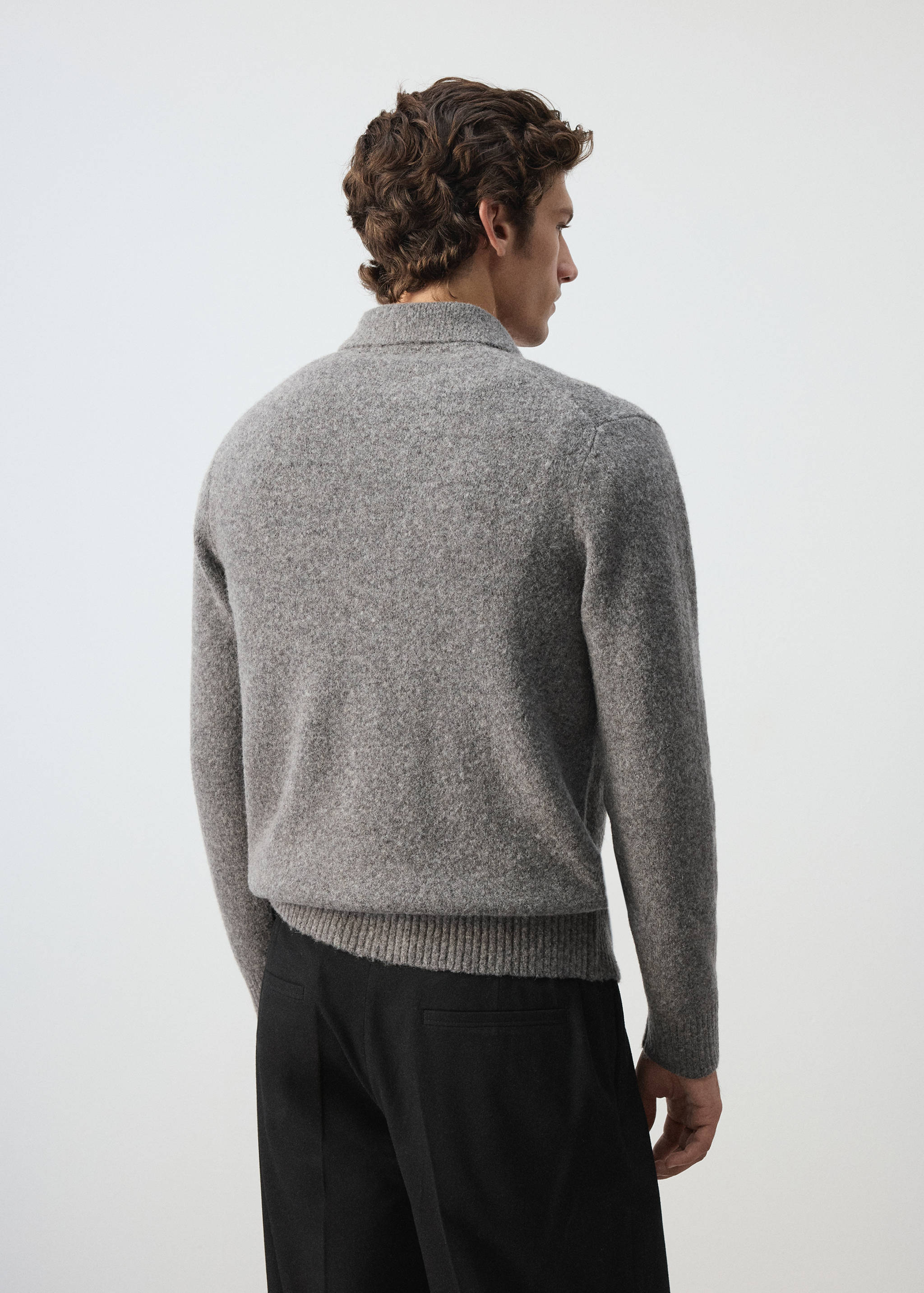 Grey knitted shirt shown from the back, featuring a ribbed collar.