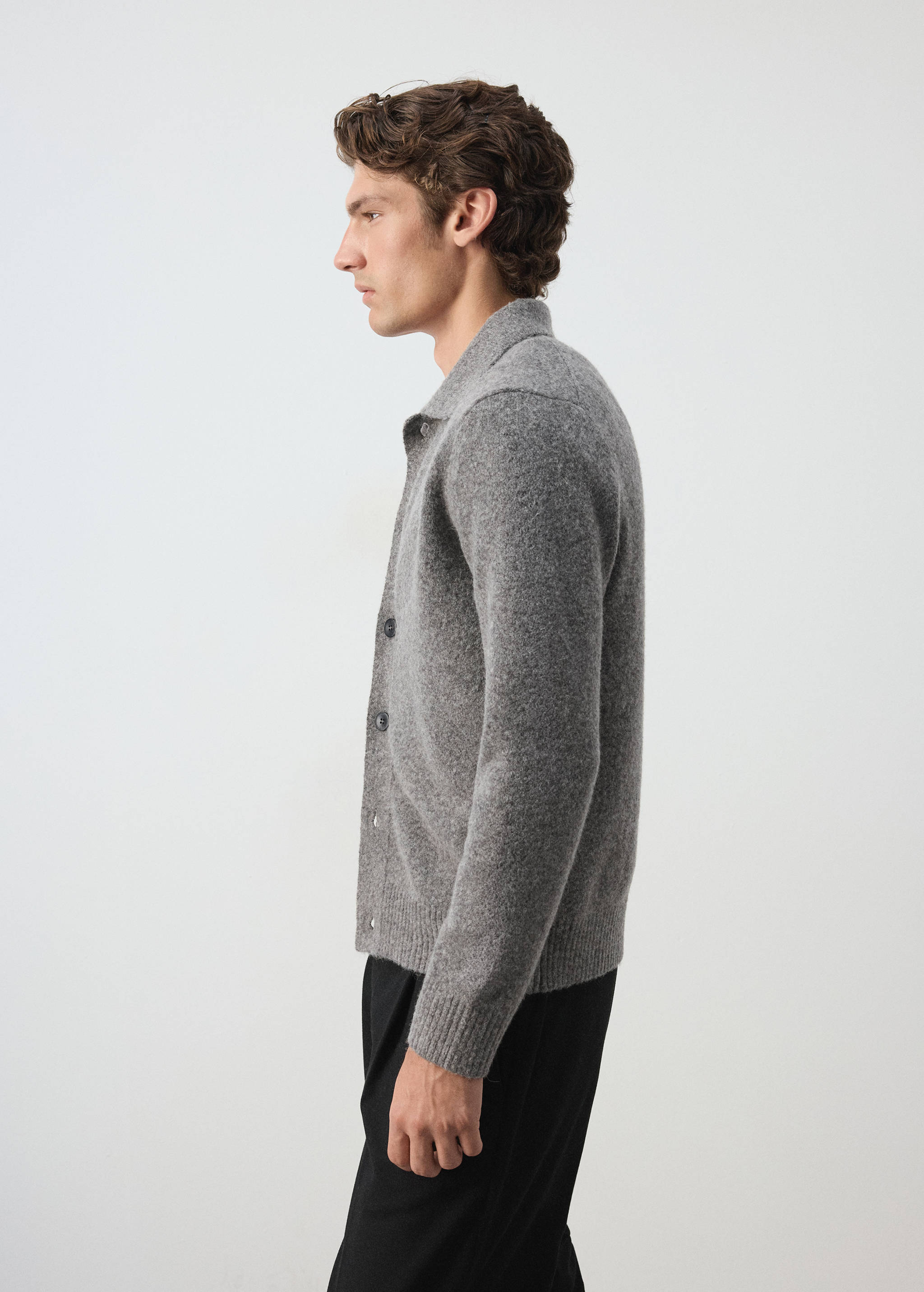 Grey knitted shirt with a collar and button fastening, side view.