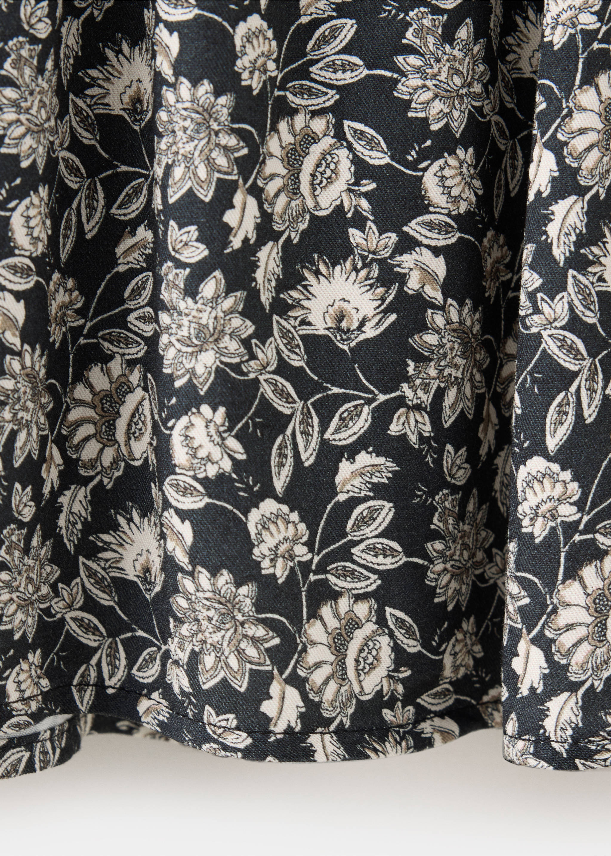 Close-up of the black dress fabric with a cream and grey floral print., Black. Ref: 37057936-00.