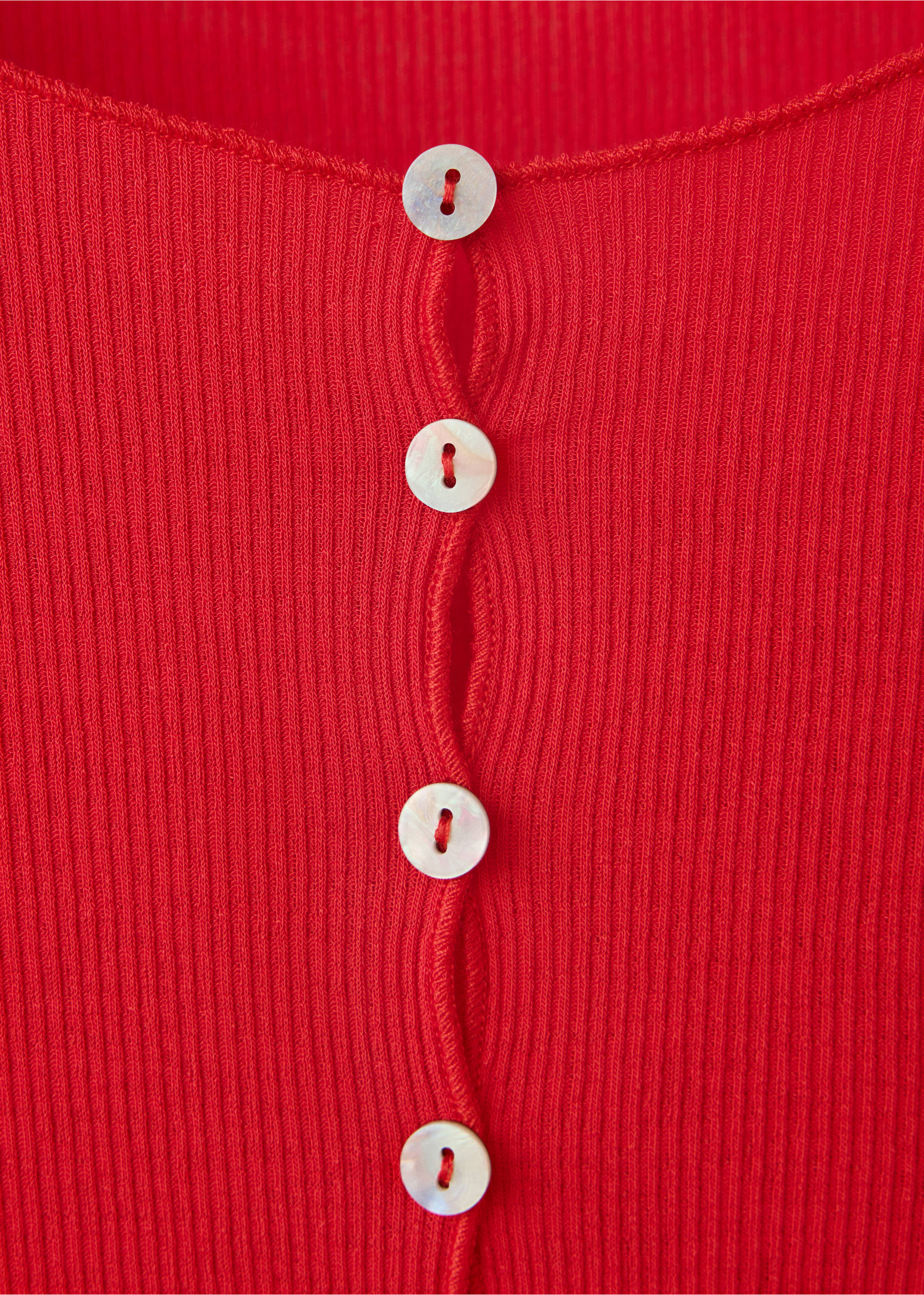 Close-up of a red ribbed t-shirt featuring a buttoned placket., Red. Ref: 37057938-00.