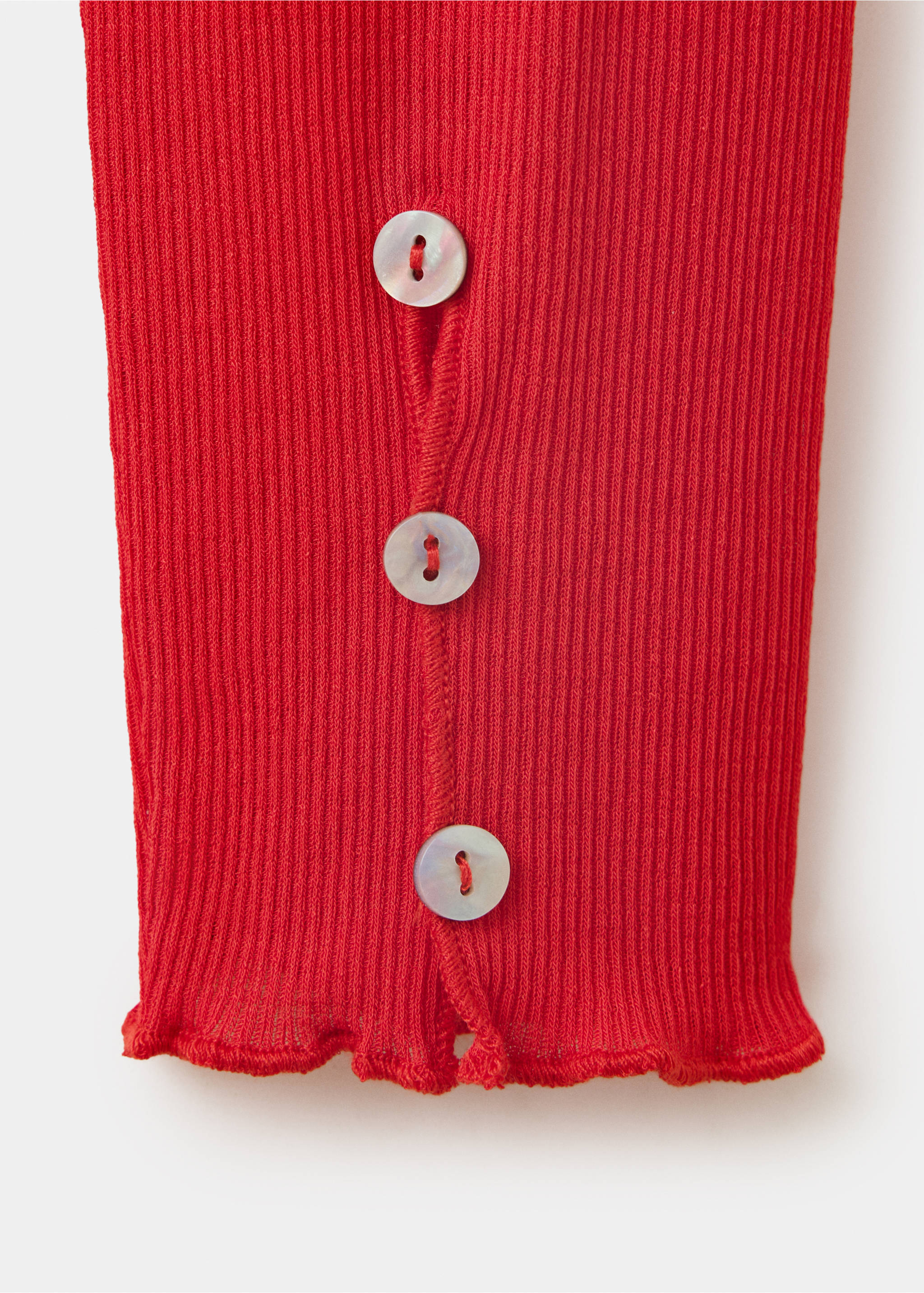 Close-up of a red ribbed t-shirt sleeve with button cuffs., Red. Ref: 37057938-00.