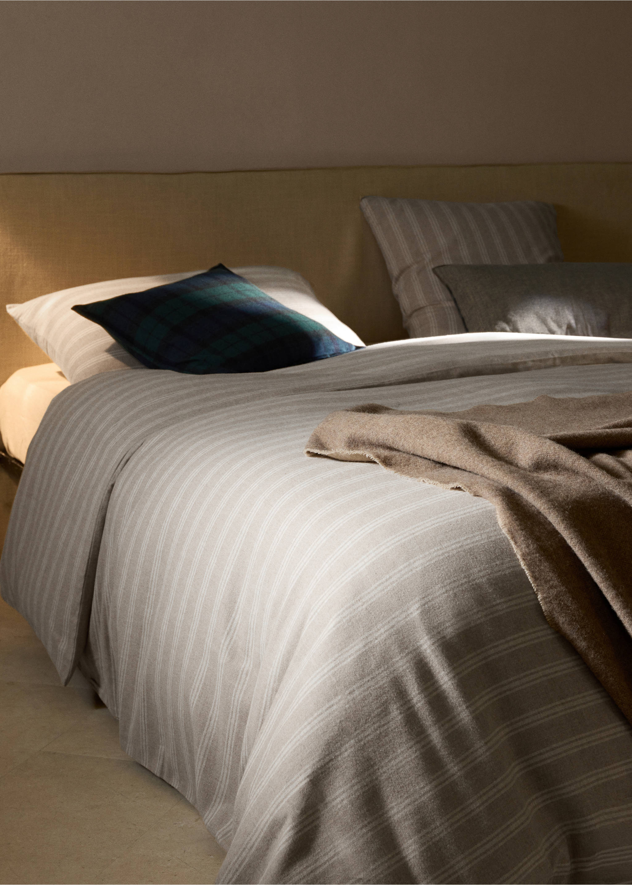 Grey and white striped duvet cover on a made bed with pillows and a brown throw., Beige. Ref: 37058266-00.