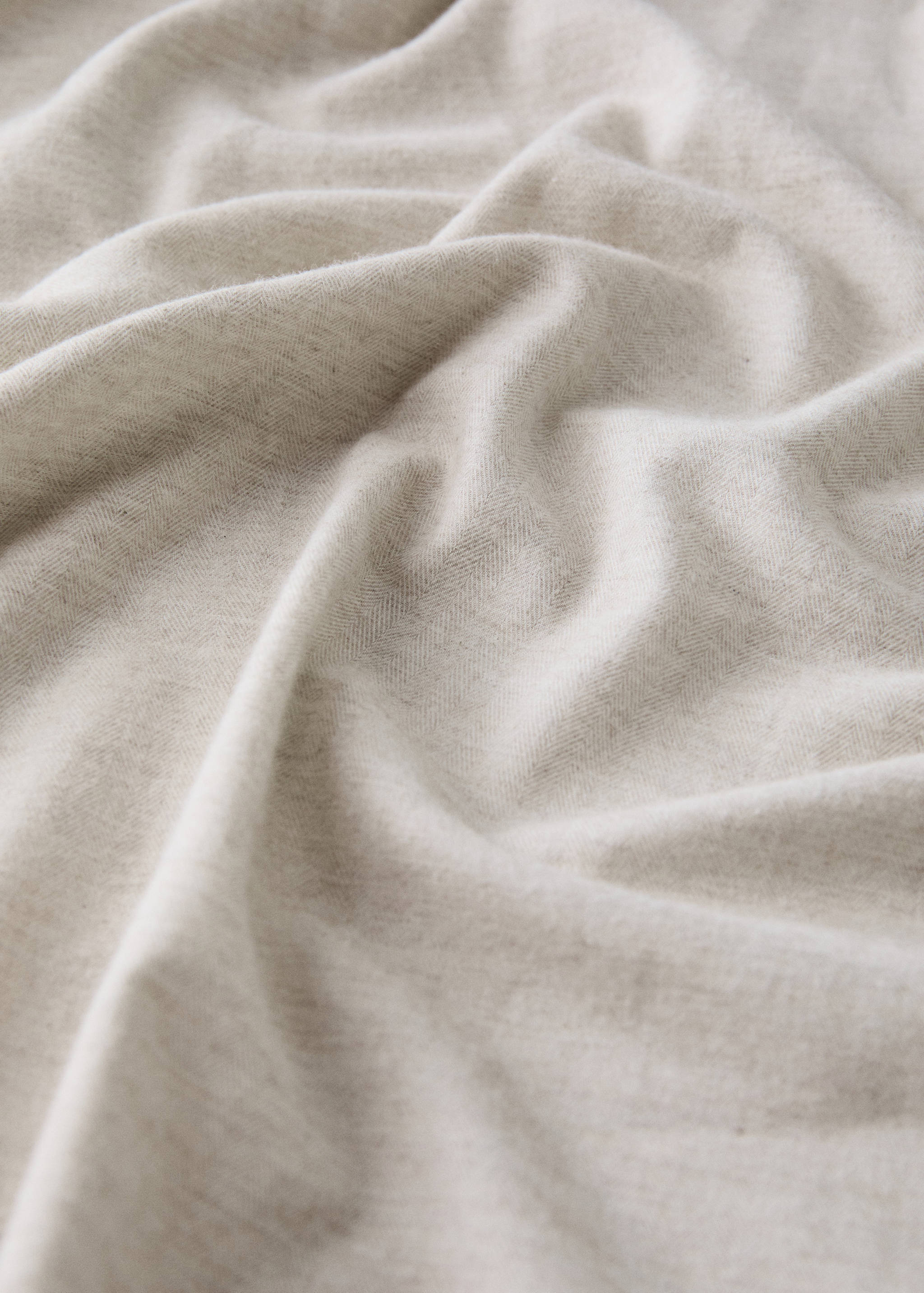 Close-up of a light beige fitted sheet texture.