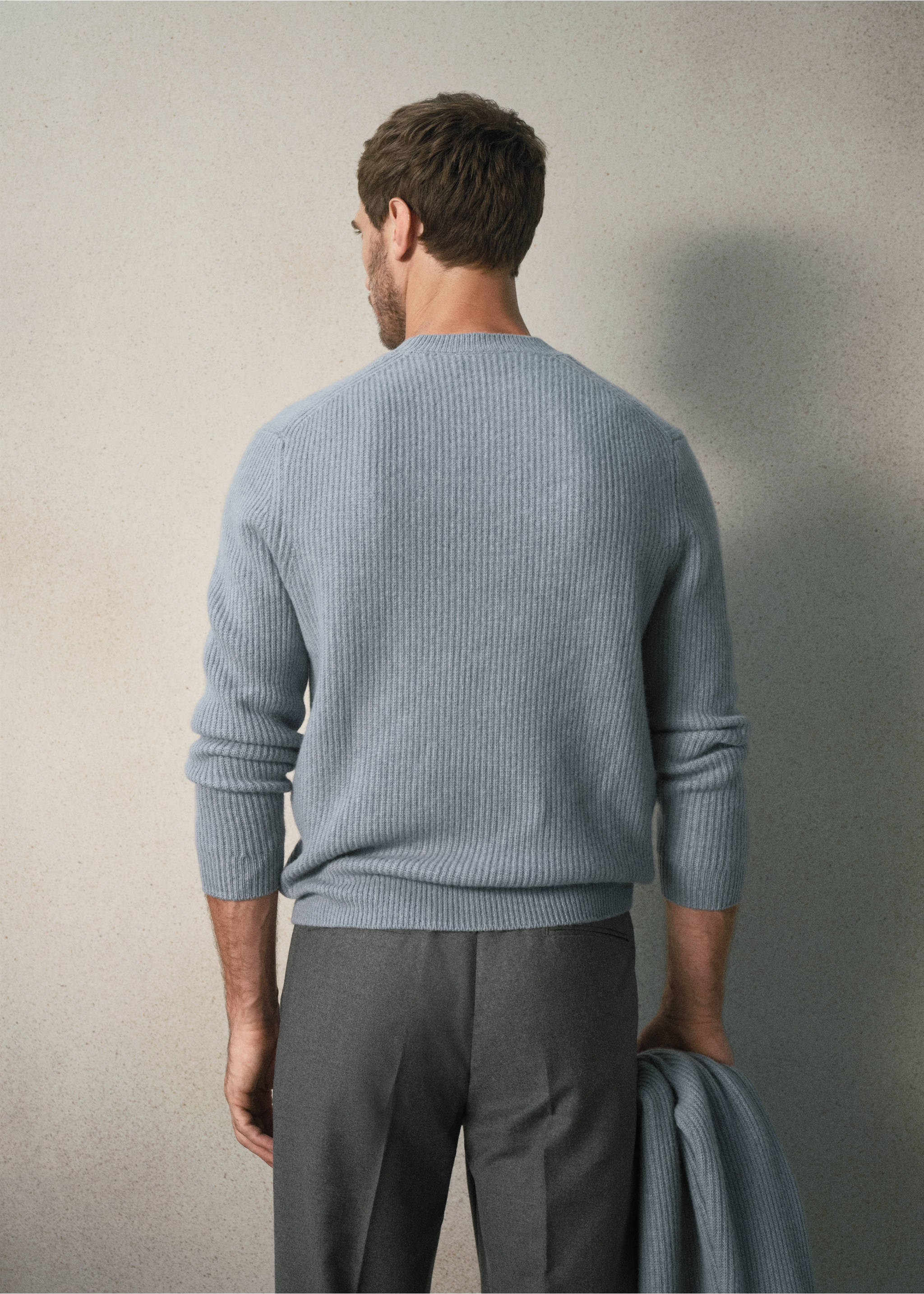 Light blue ribbed knit jersey viewed from the back, worn with grey trousers., Sky Blue. Ref: 37058274-00.