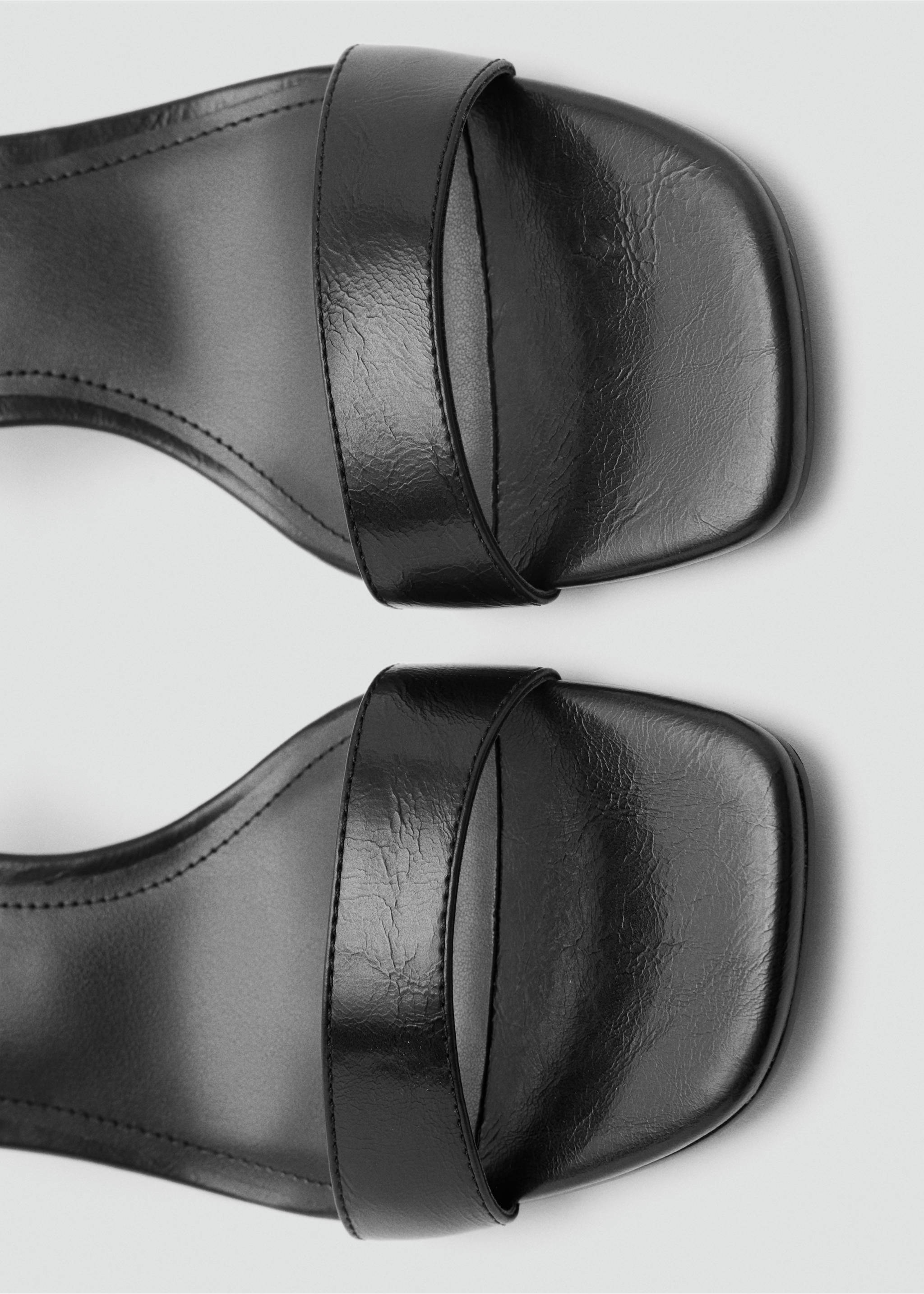 Close-up of black square-toe sandals featuring a single forefoot strap., Black. Ref: 37058279-00.