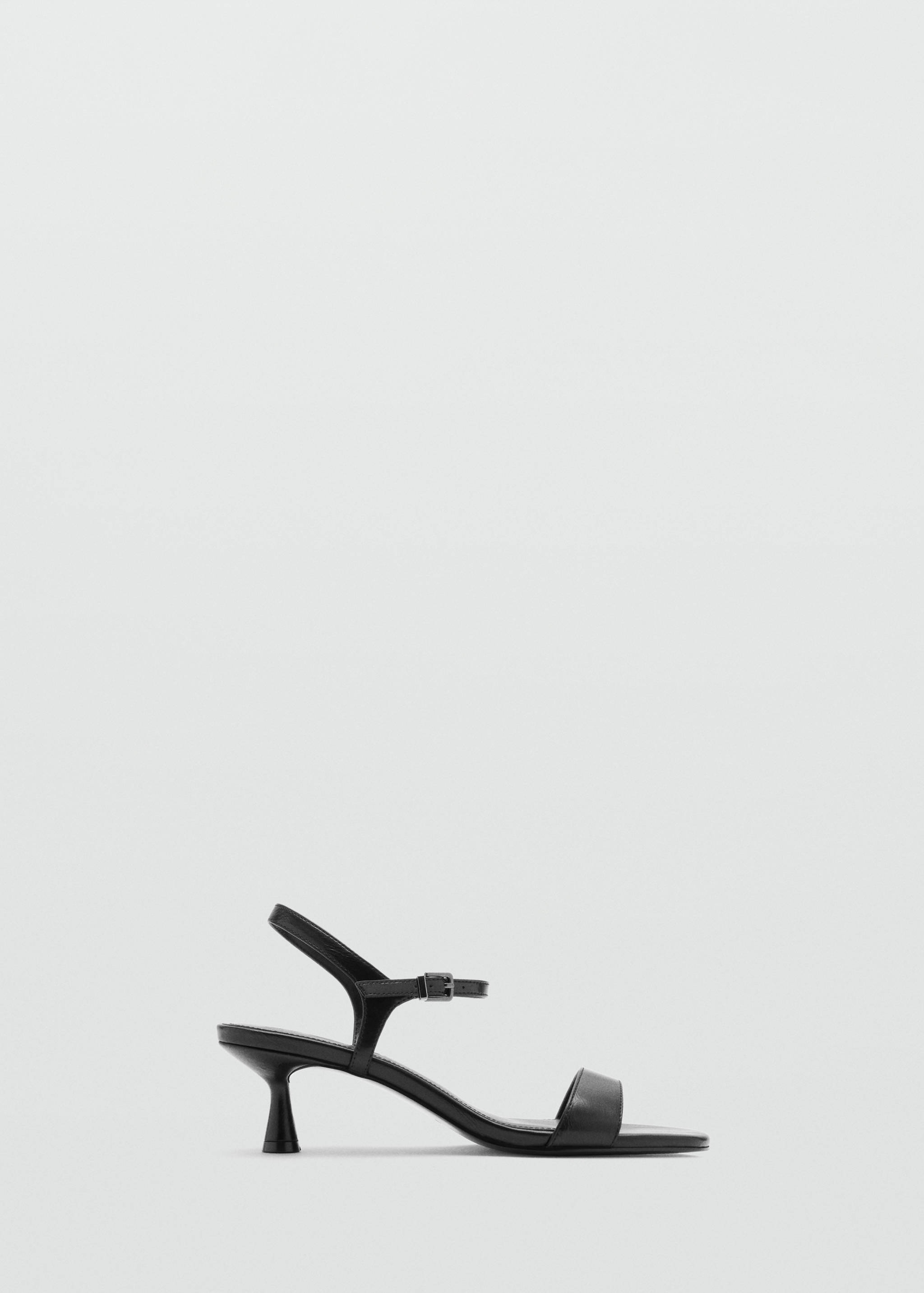 Black kitten-heel sandal with a narrow toe strap and slingback buckle.