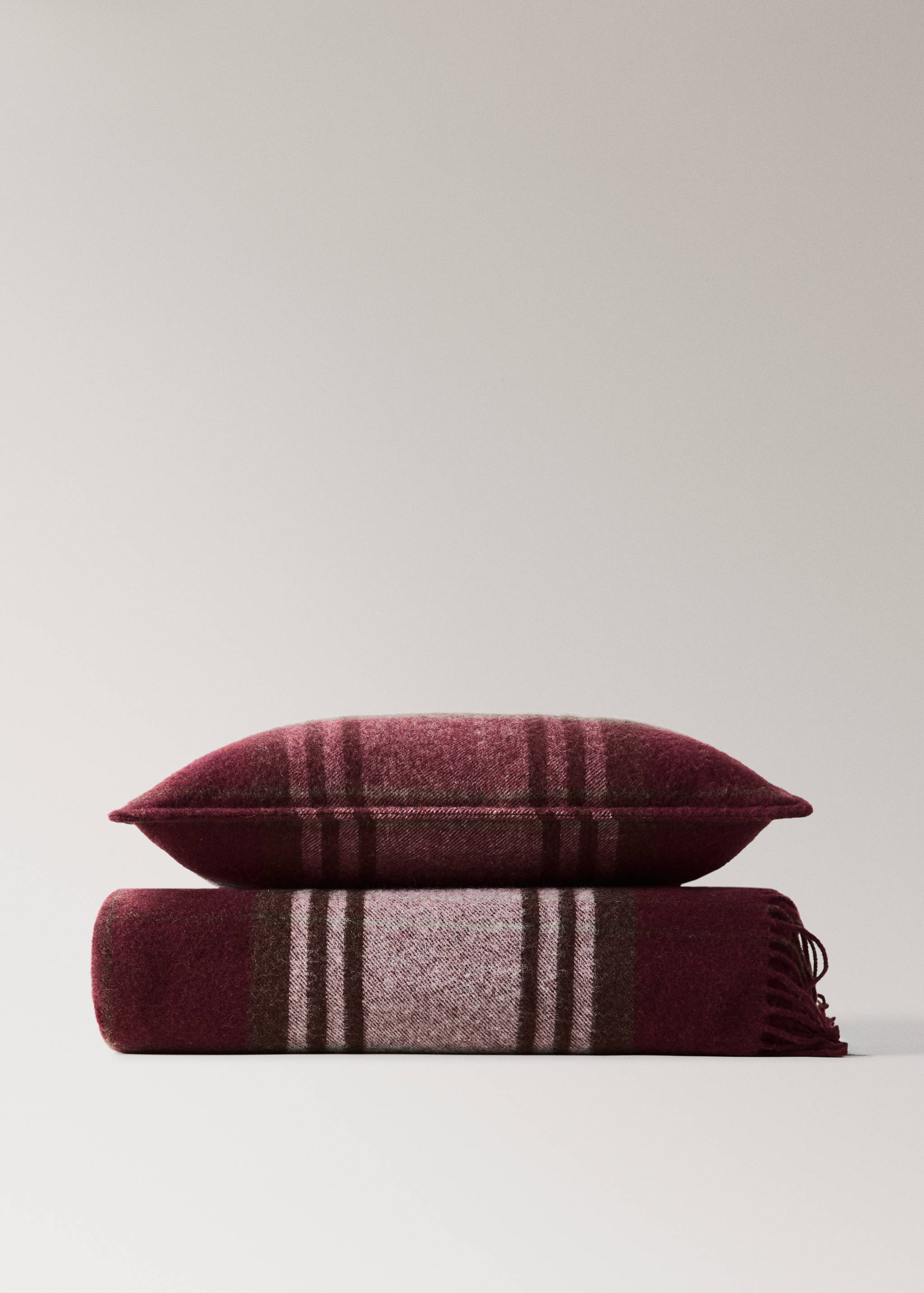 Burgundy plaid cushion cover in a textured wool-blend fabric.