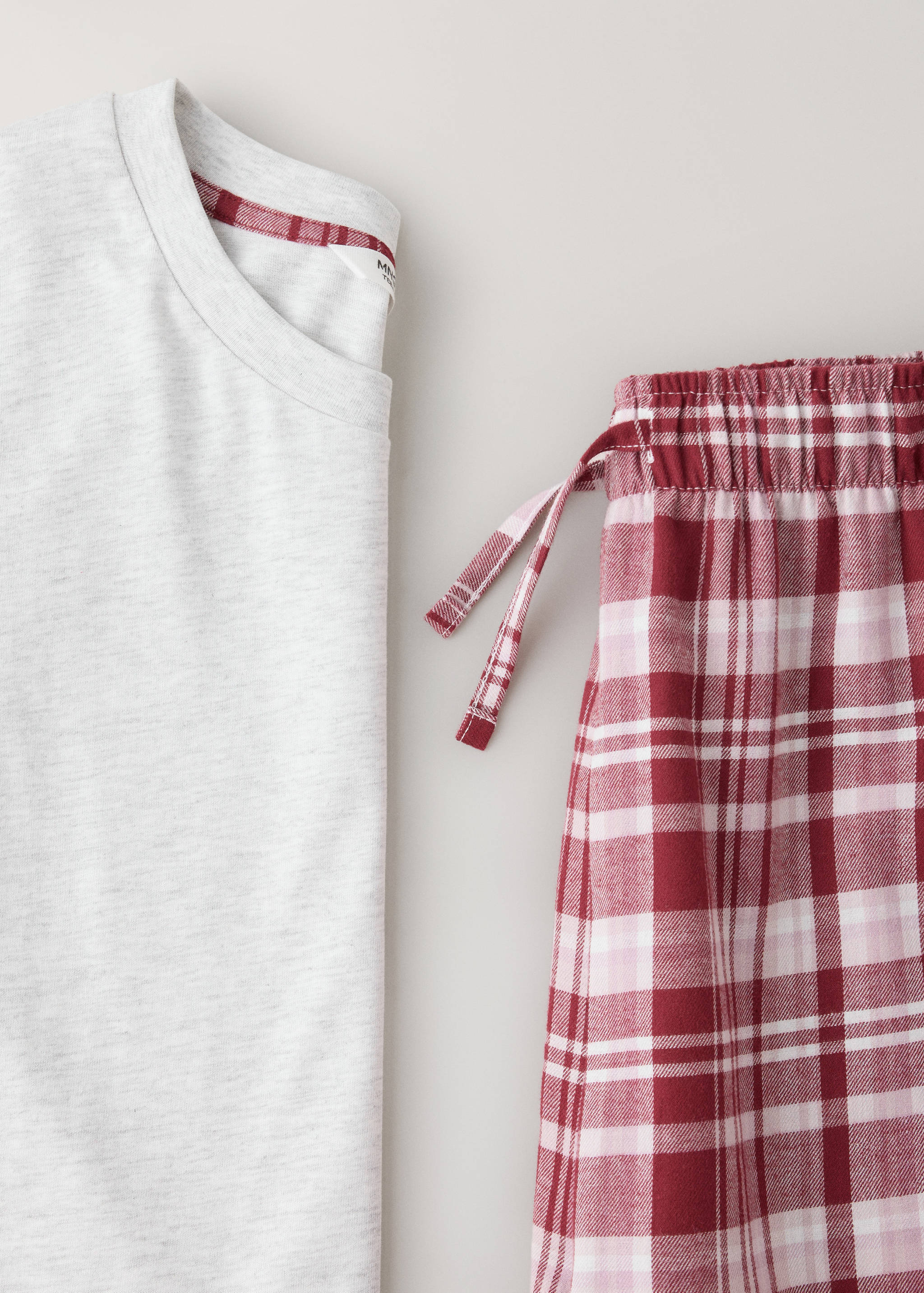 Grey marl top and red plaid pyjama trousers, fabric detail.