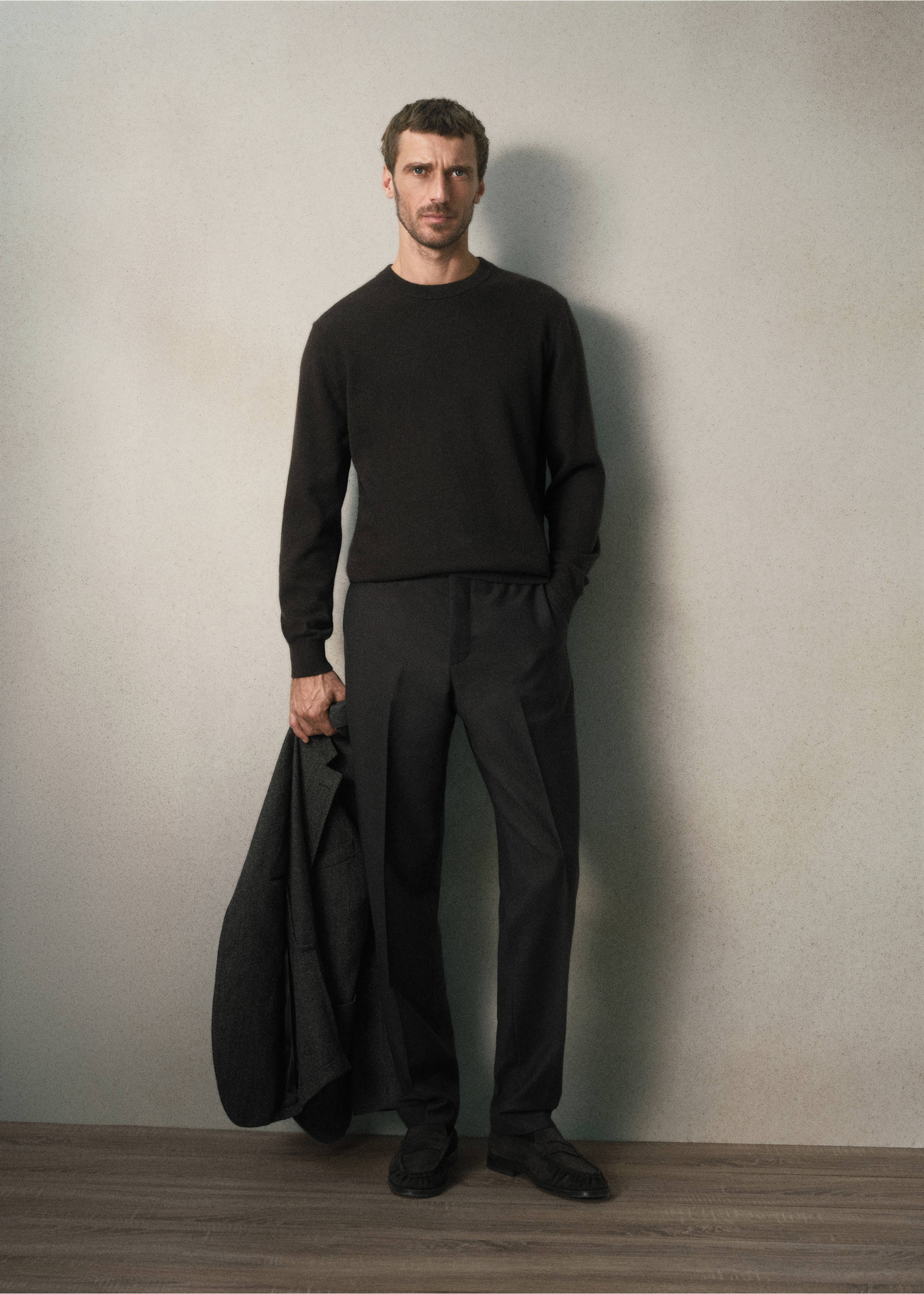 Dark grey trousers with a pressed crease, worn with a dark sweater and loafers., Brown. Ref: 37058630-00.