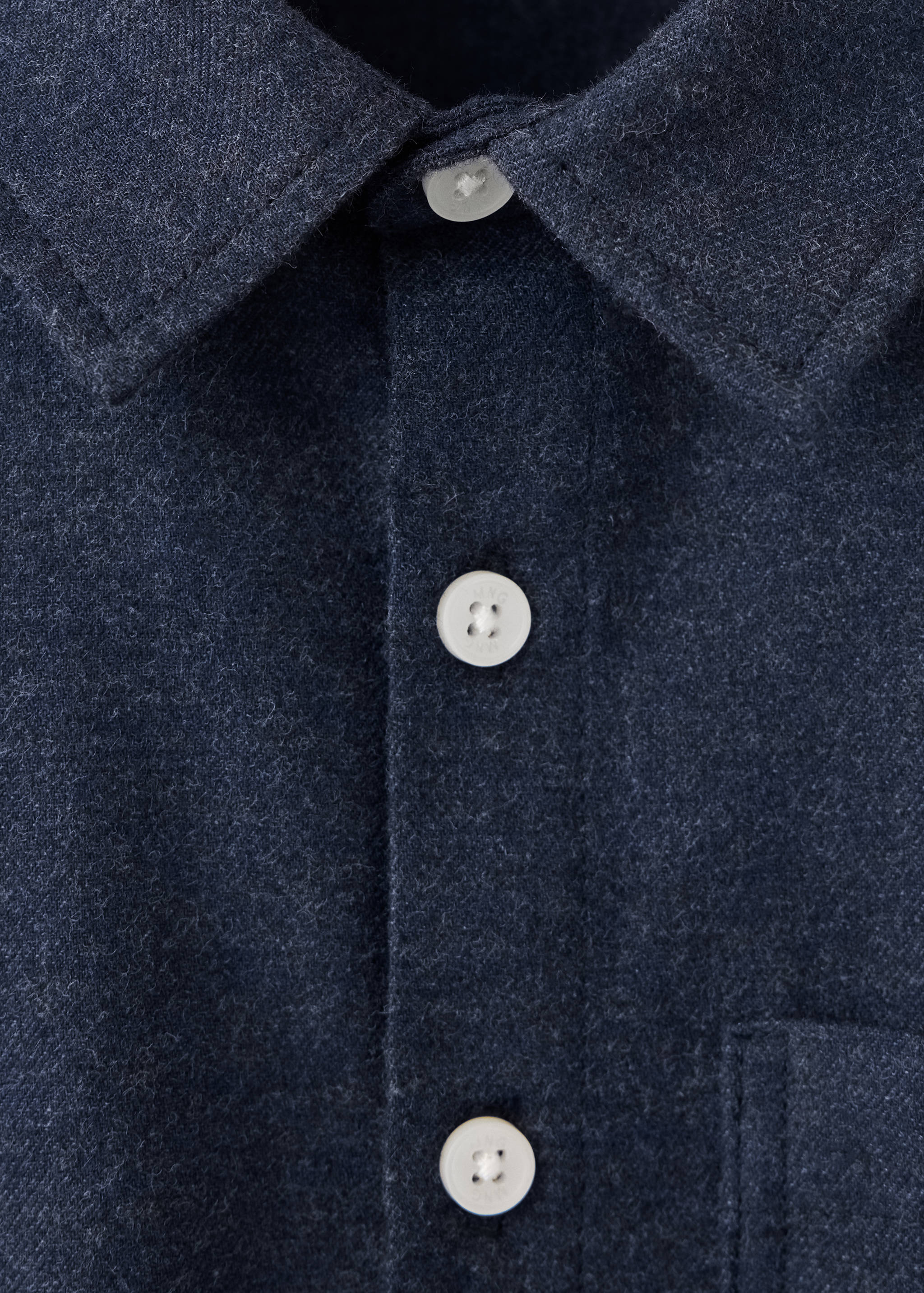 Close-up of a dark blue kids' flannel shirt featuring a classic collar and light buttons.