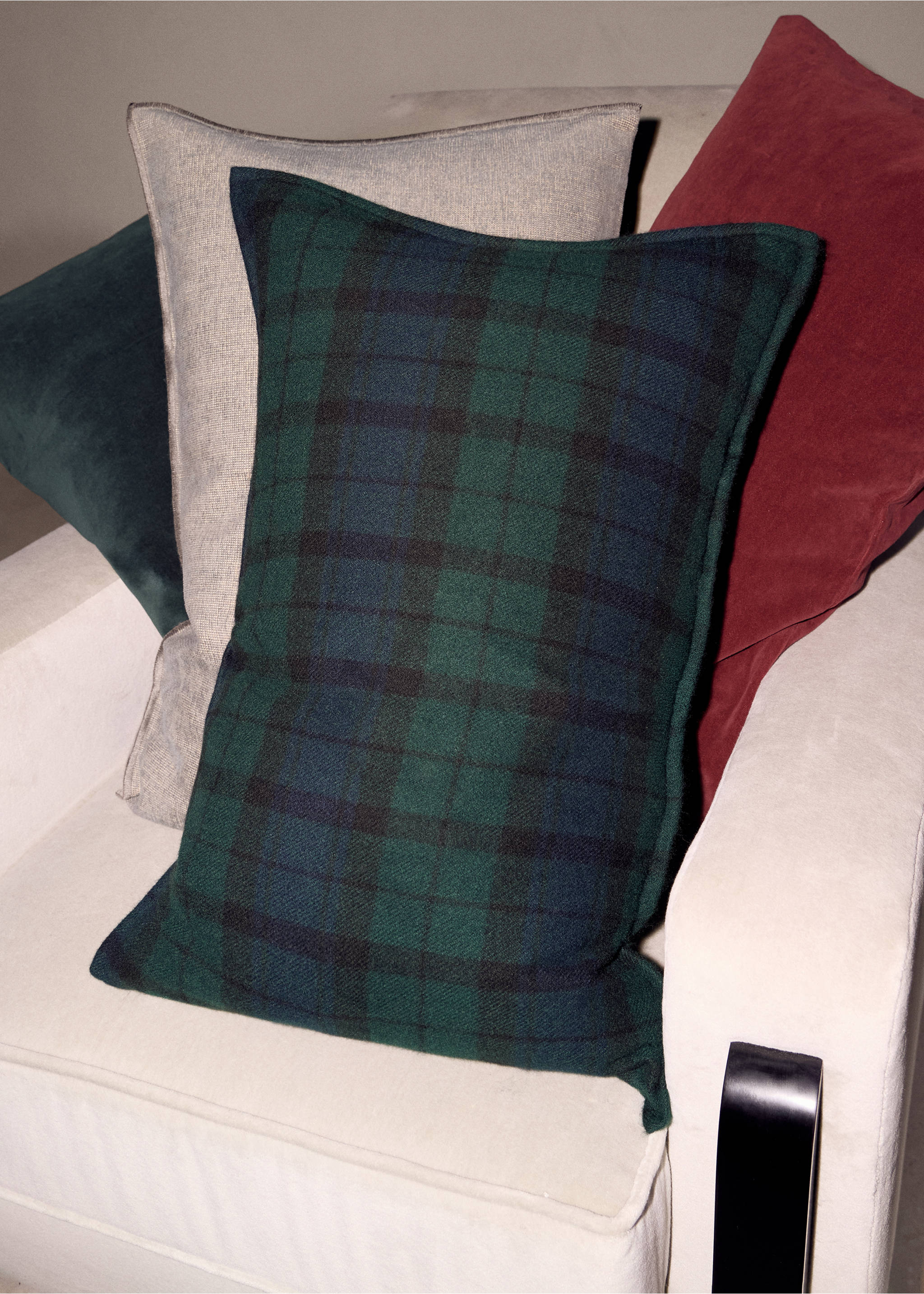 Green and navy blue plaid cushion cover, styled with other cushions on an armchair., Blue. Ref: 37058633-00.
