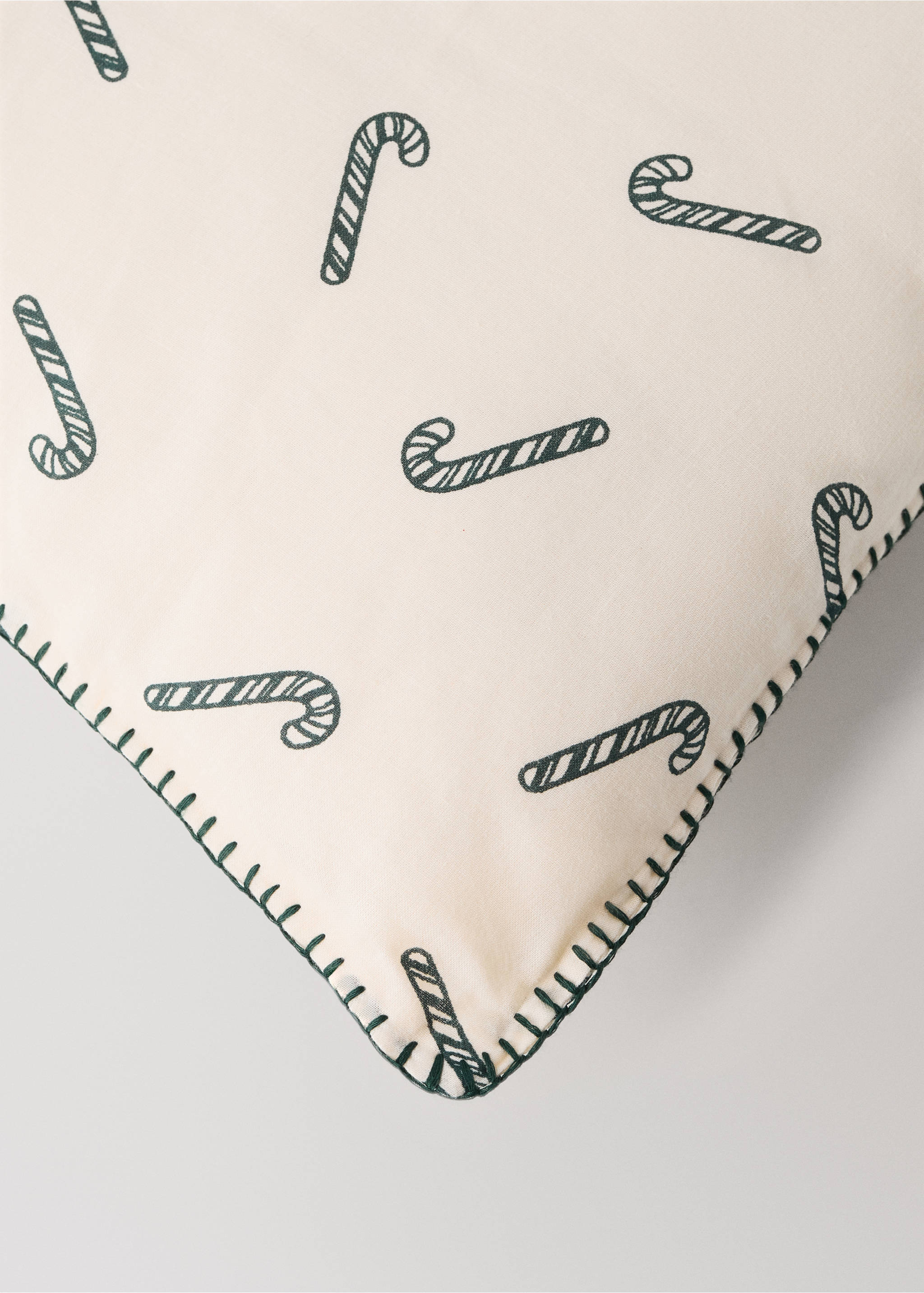Cream cushion with a dark green candy cane print and whipstitch trim., Red. Ref: 37058635-00.