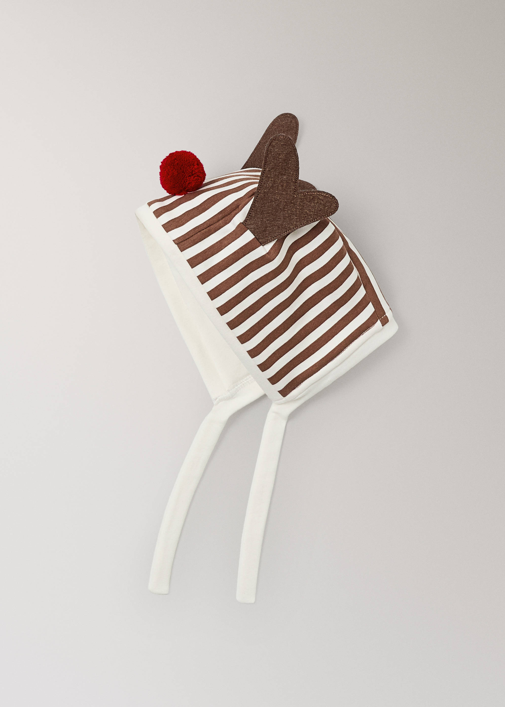 Brown and white striped baby bonnet with ears and red pom-pom.
