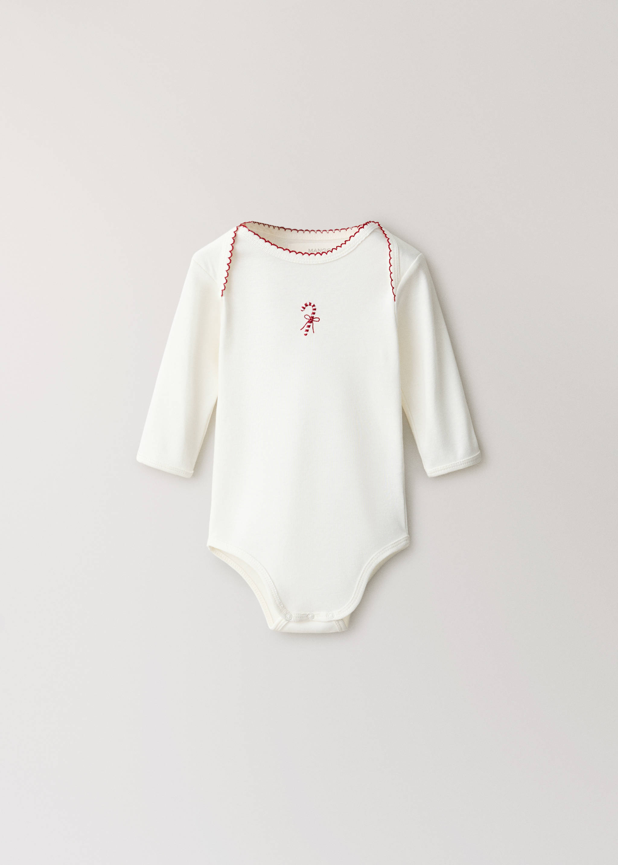 White long-sleeved baby body with red scalloped trim and candy cane embroidery.