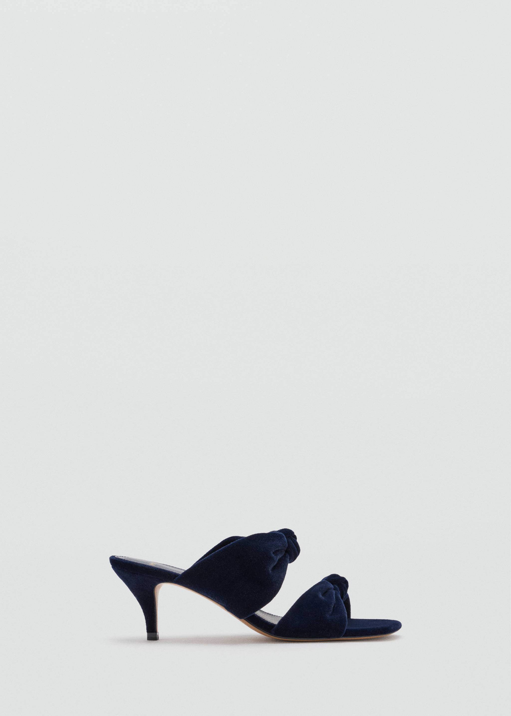 Navy blue velvet heeled sandal with knotted straps and a stiletto heel.