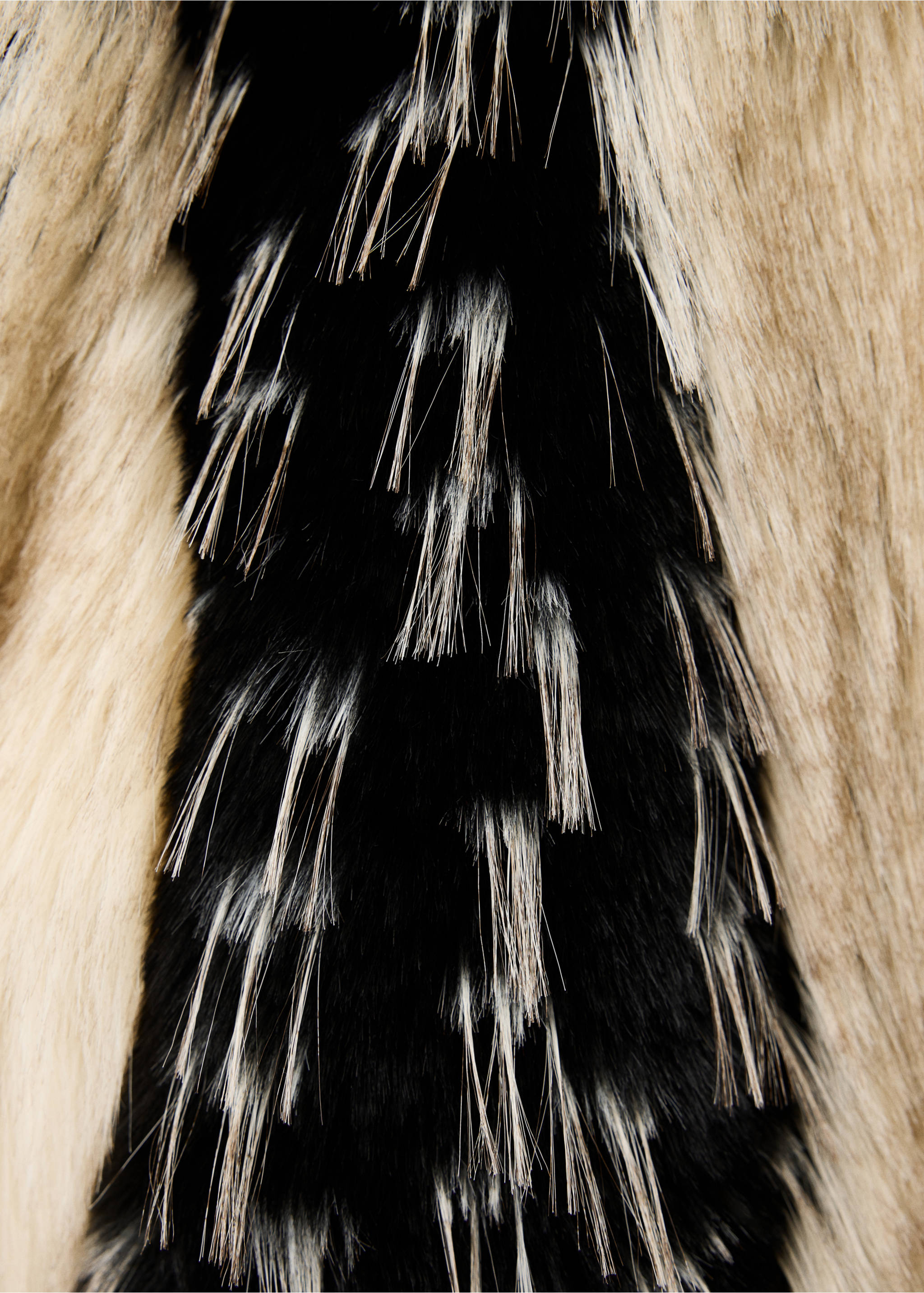 Close-up of a jacket's textured black and beige faux-fur fabric., Black. Ref: 37059114-00.