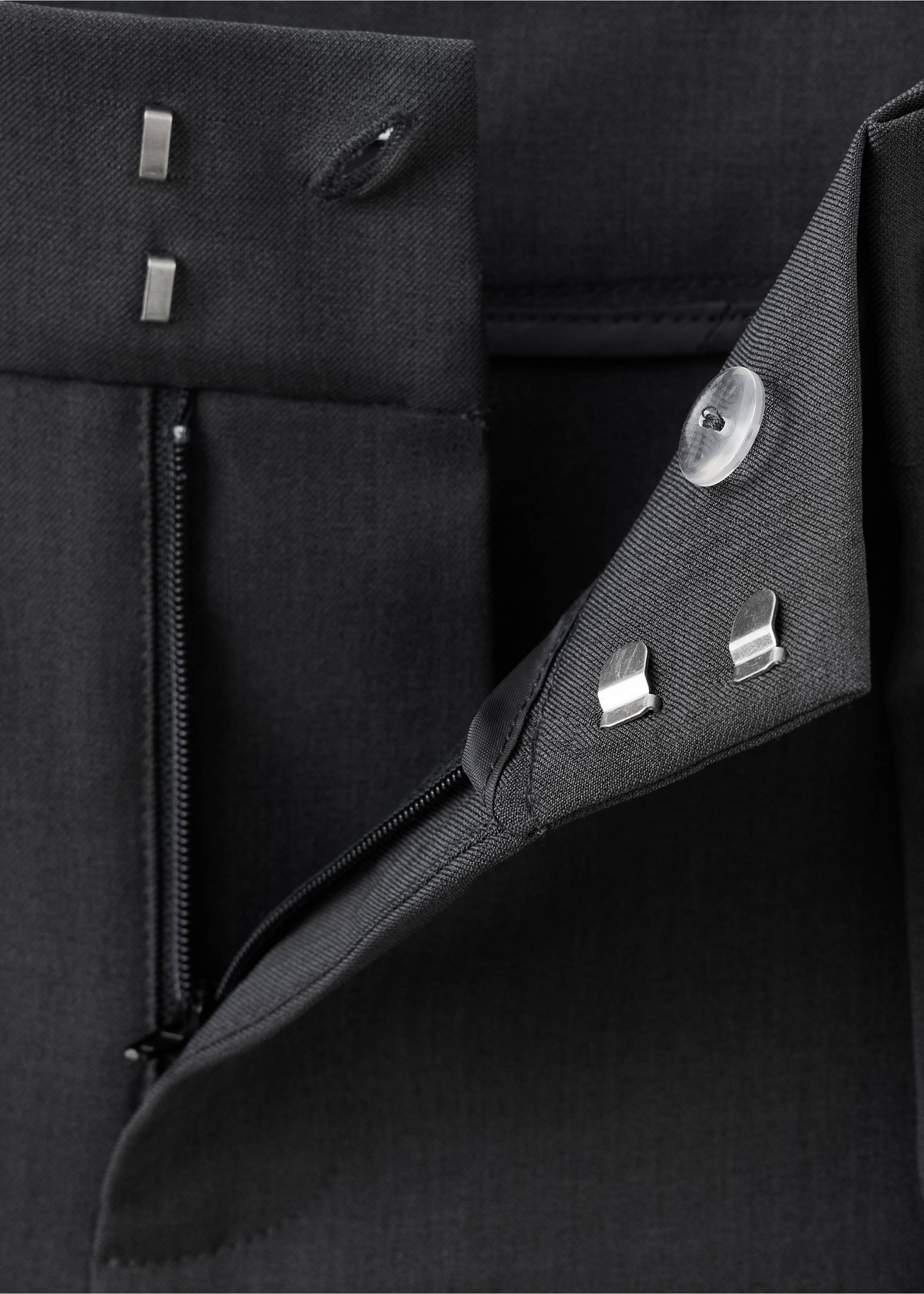 Close-up of black trousers showing the waistband and fastening details., Grey. Ref: 37059117-00.