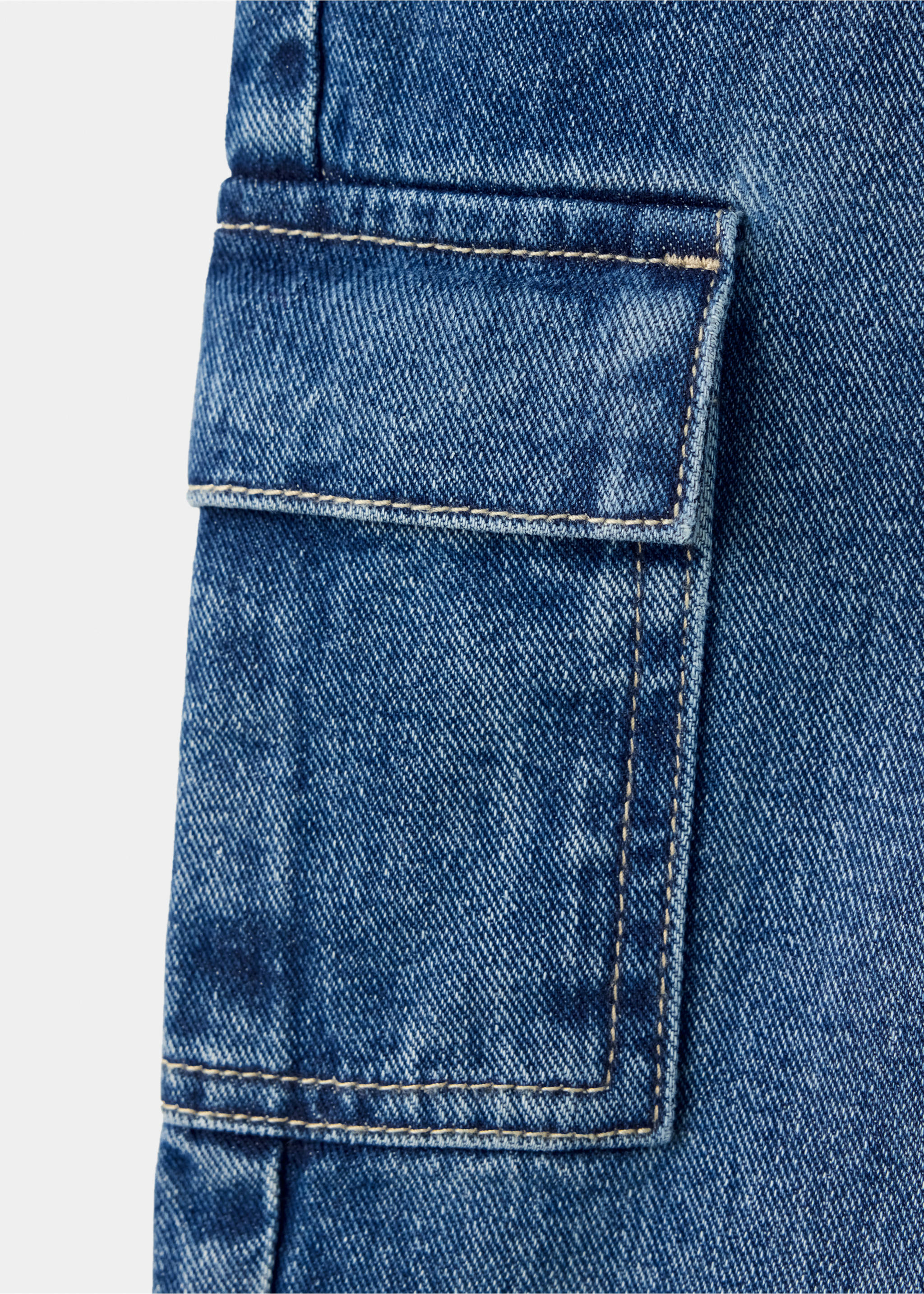 Close-up of a blue denim trousers pocket with contrast topstitching., Dark Blue. Ref: 37059121-00.