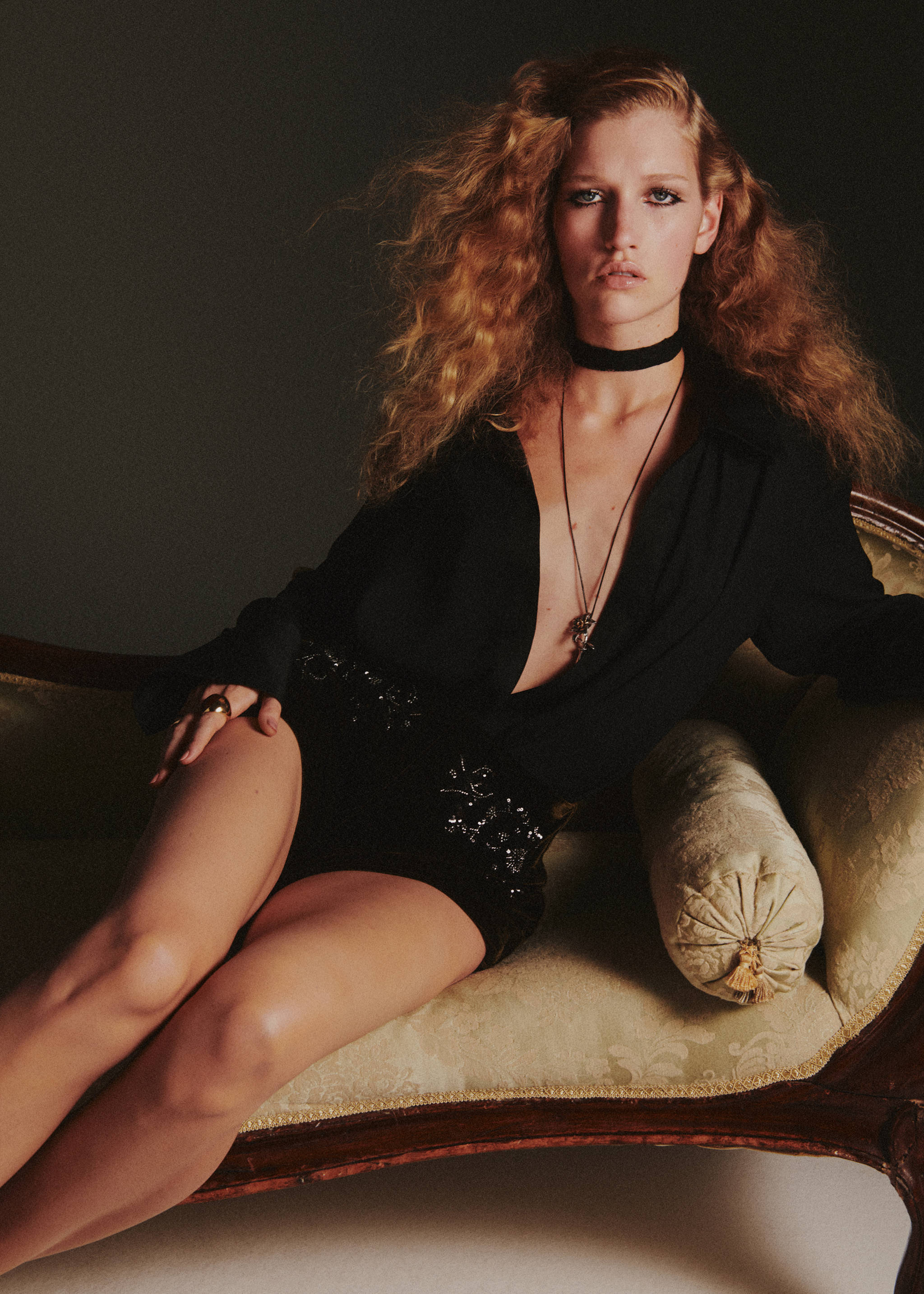 Black embellished shorts worn with a black shirt and choker.