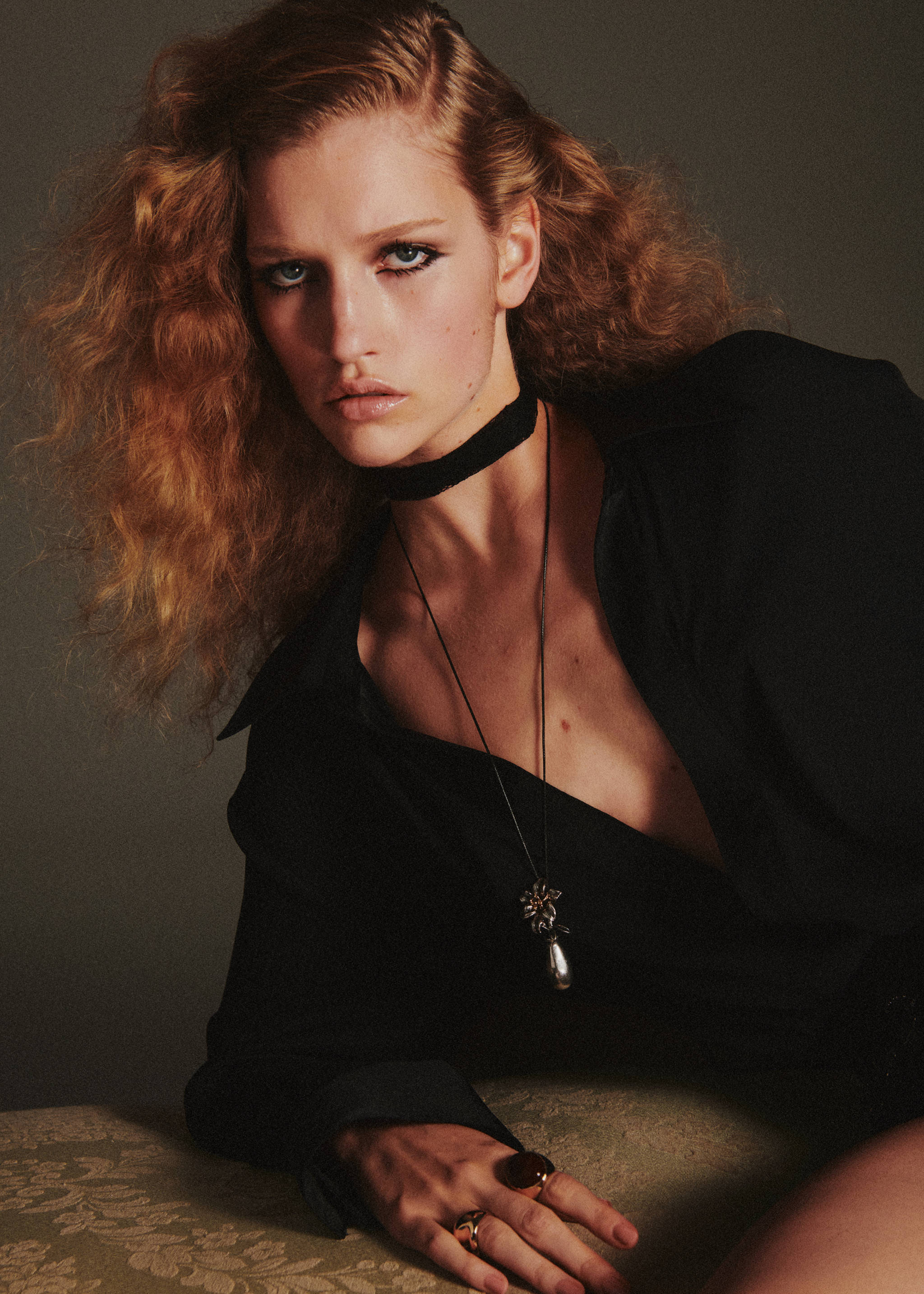 Shorts worn by a model in a close-up portrait with dark shirt and accessories.