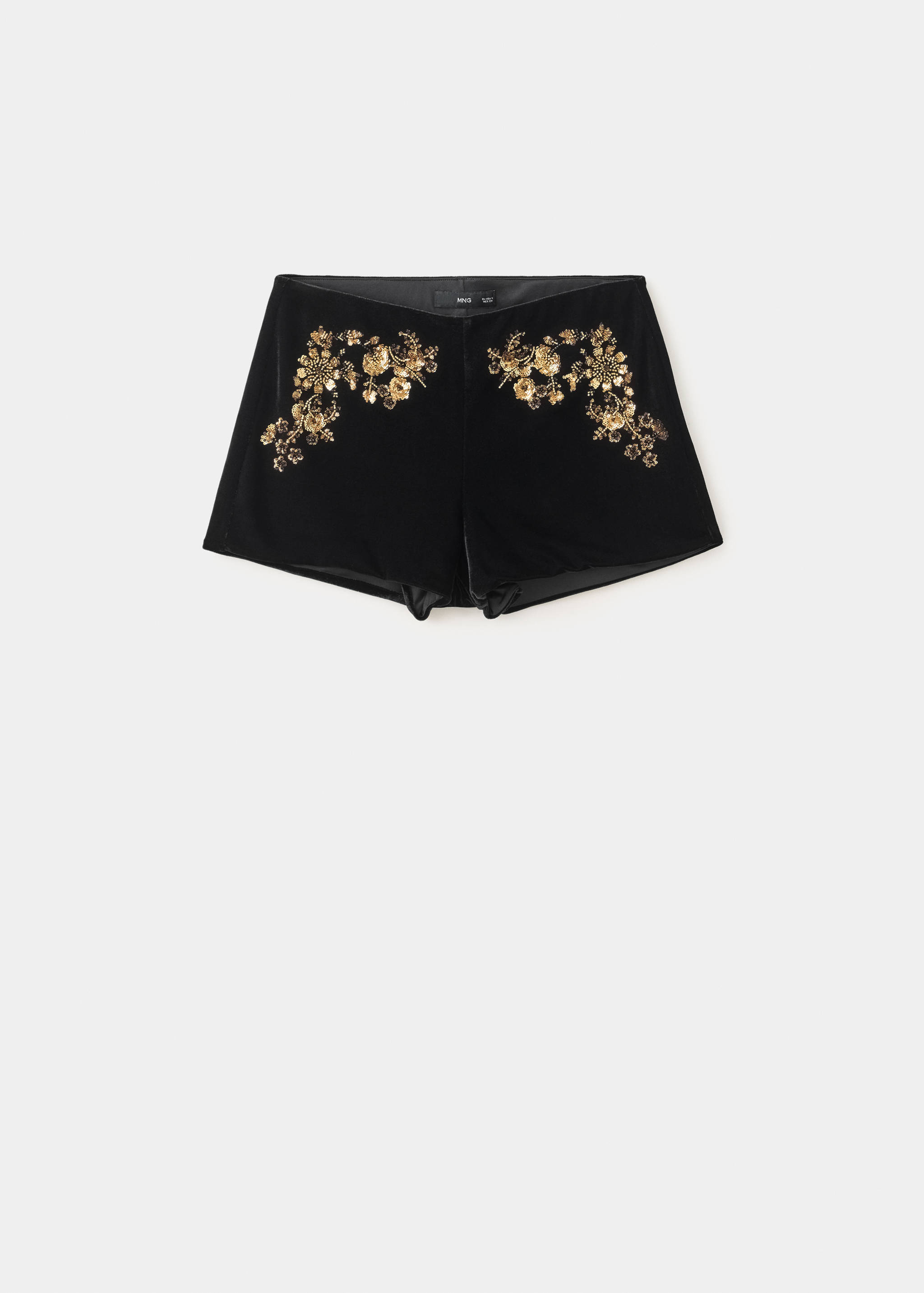 Black velvet shorts with metallic gold floral embroidery.