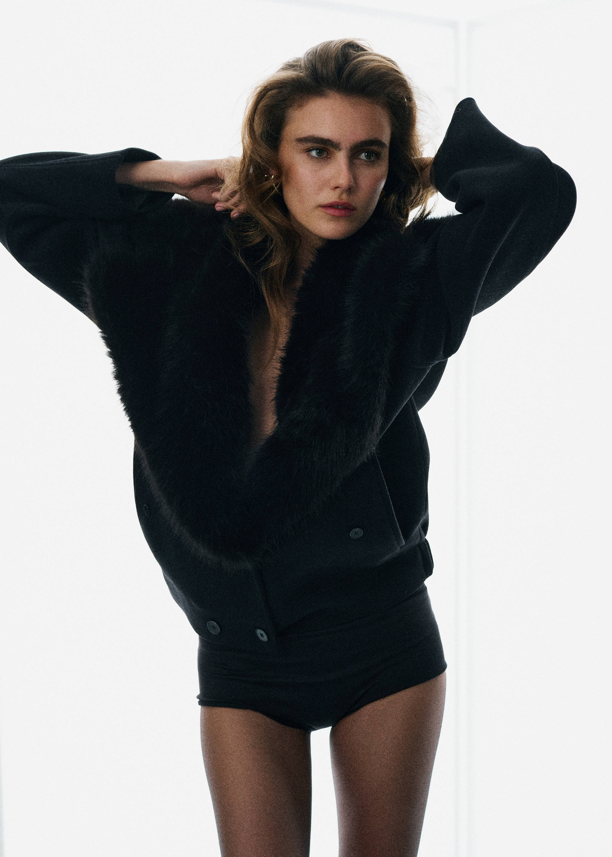 Black jacket with a plush faux-fur lapel and collar.