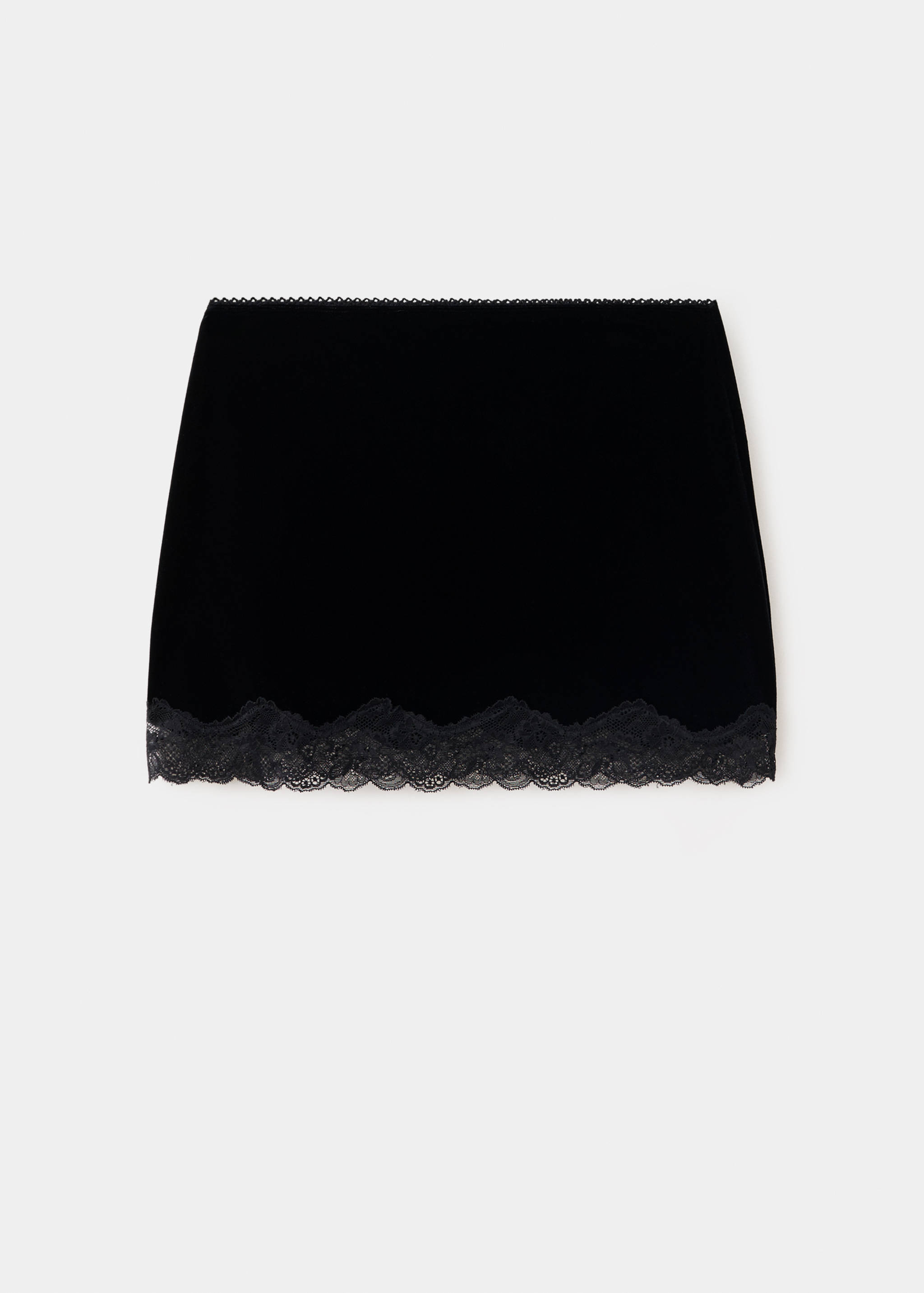 Short black velvet skirt with a scalloped lace hem.
