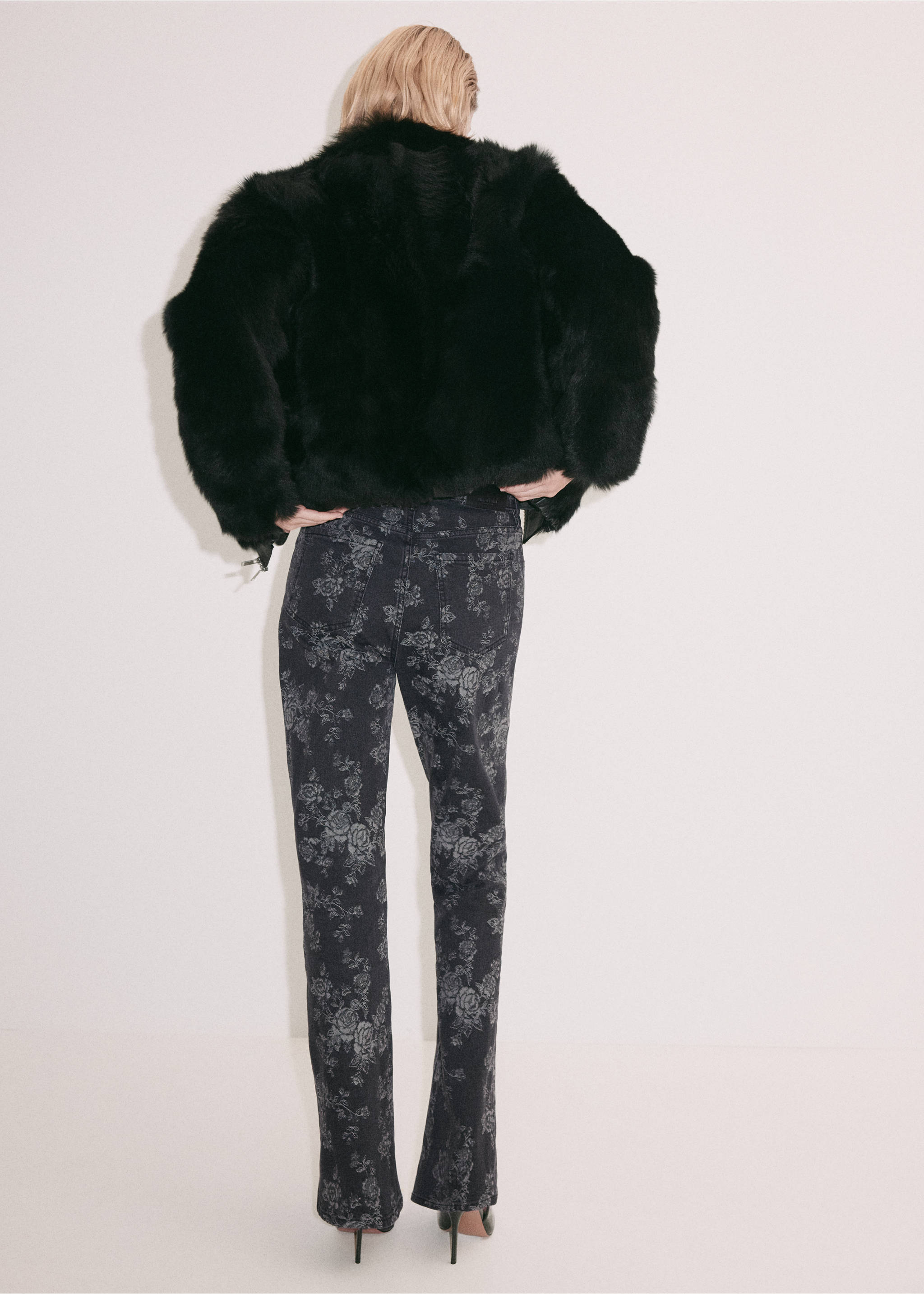 Back view of floral print dark grey trousers, worn with a black faux-fur jacket., Denim Grey. Ref: 37059134-00.