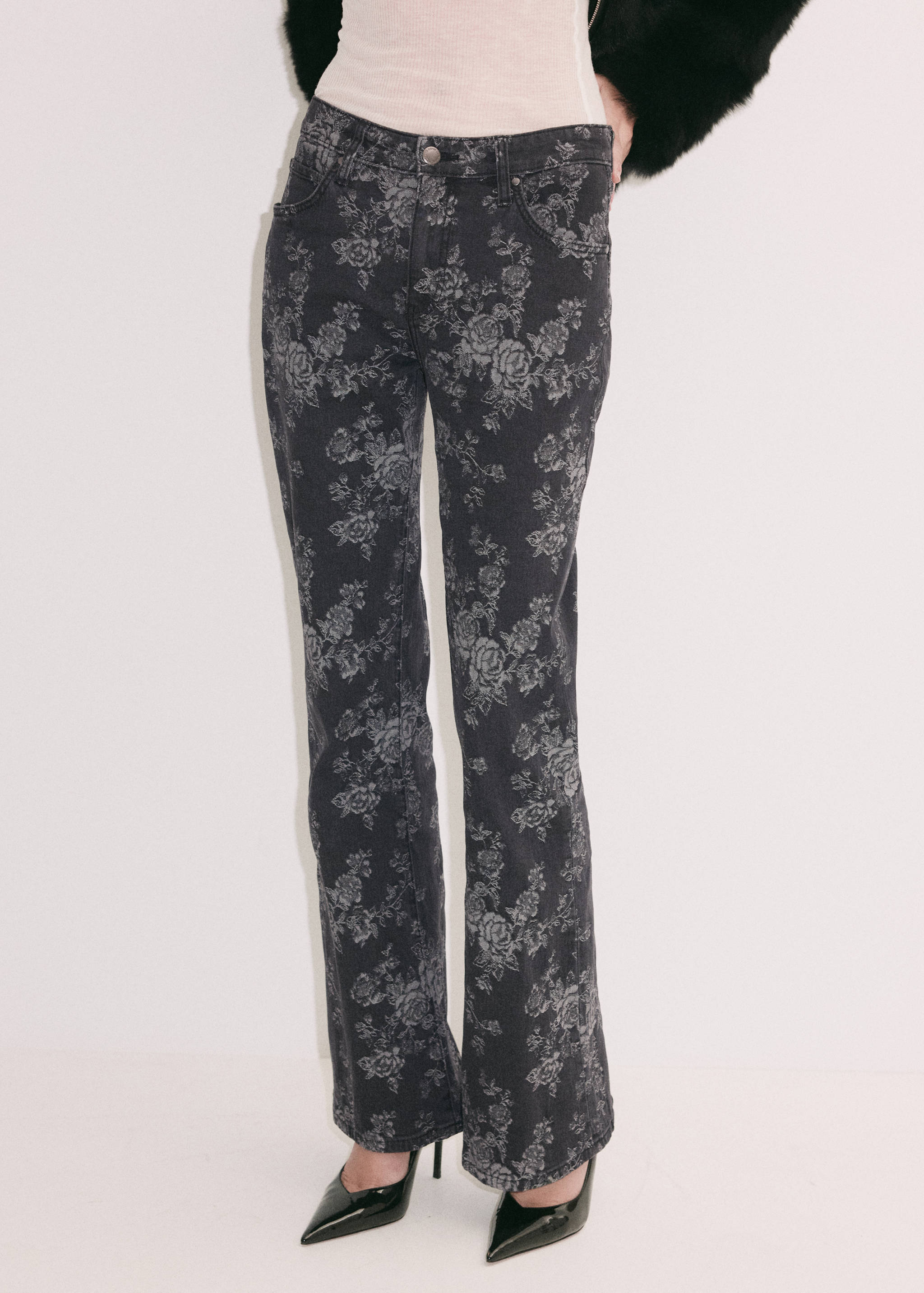 Dark grey floral-print denim trousers in a straight-leg style.