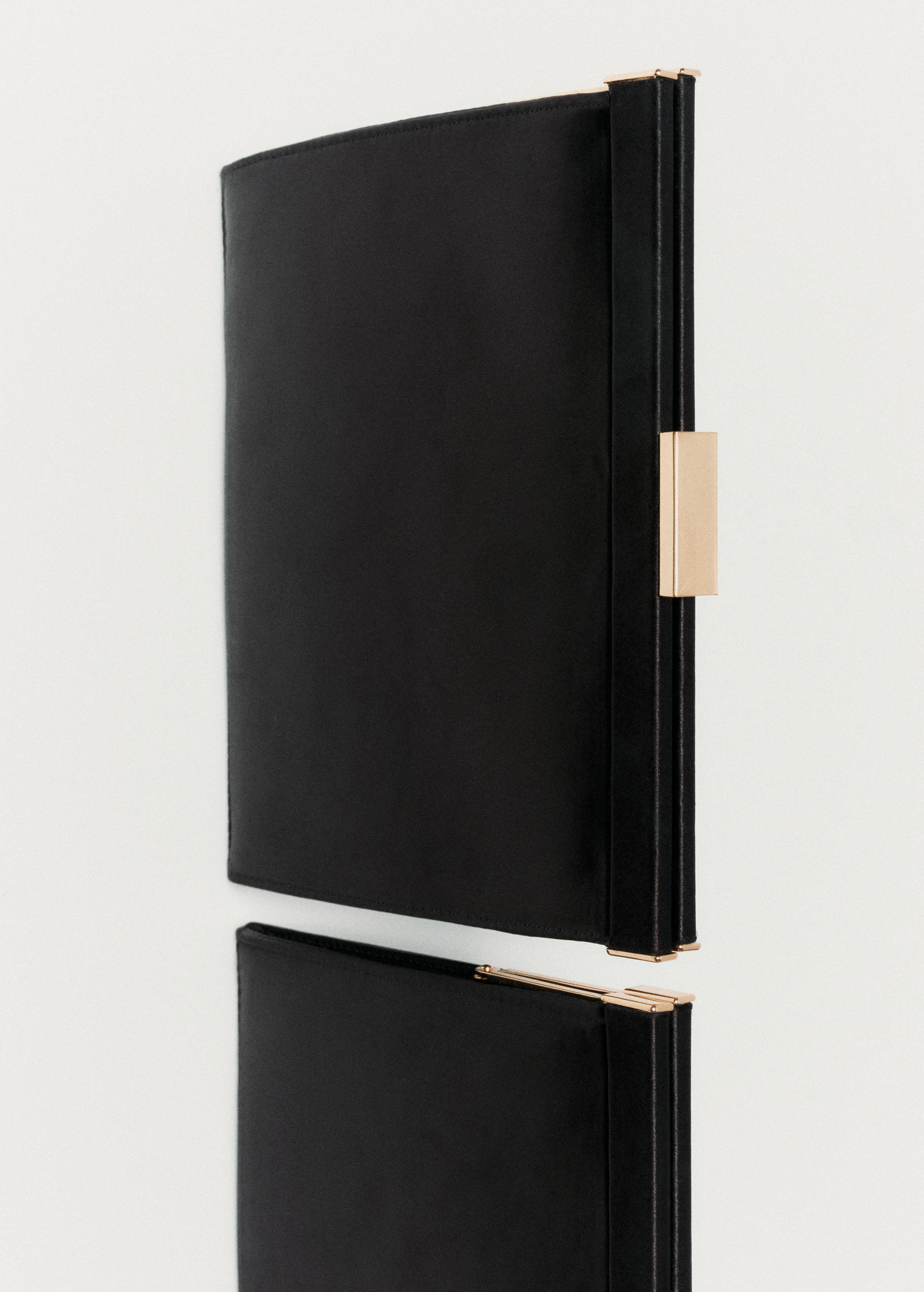 Structured black handbag with gold-toned metal frame closure.