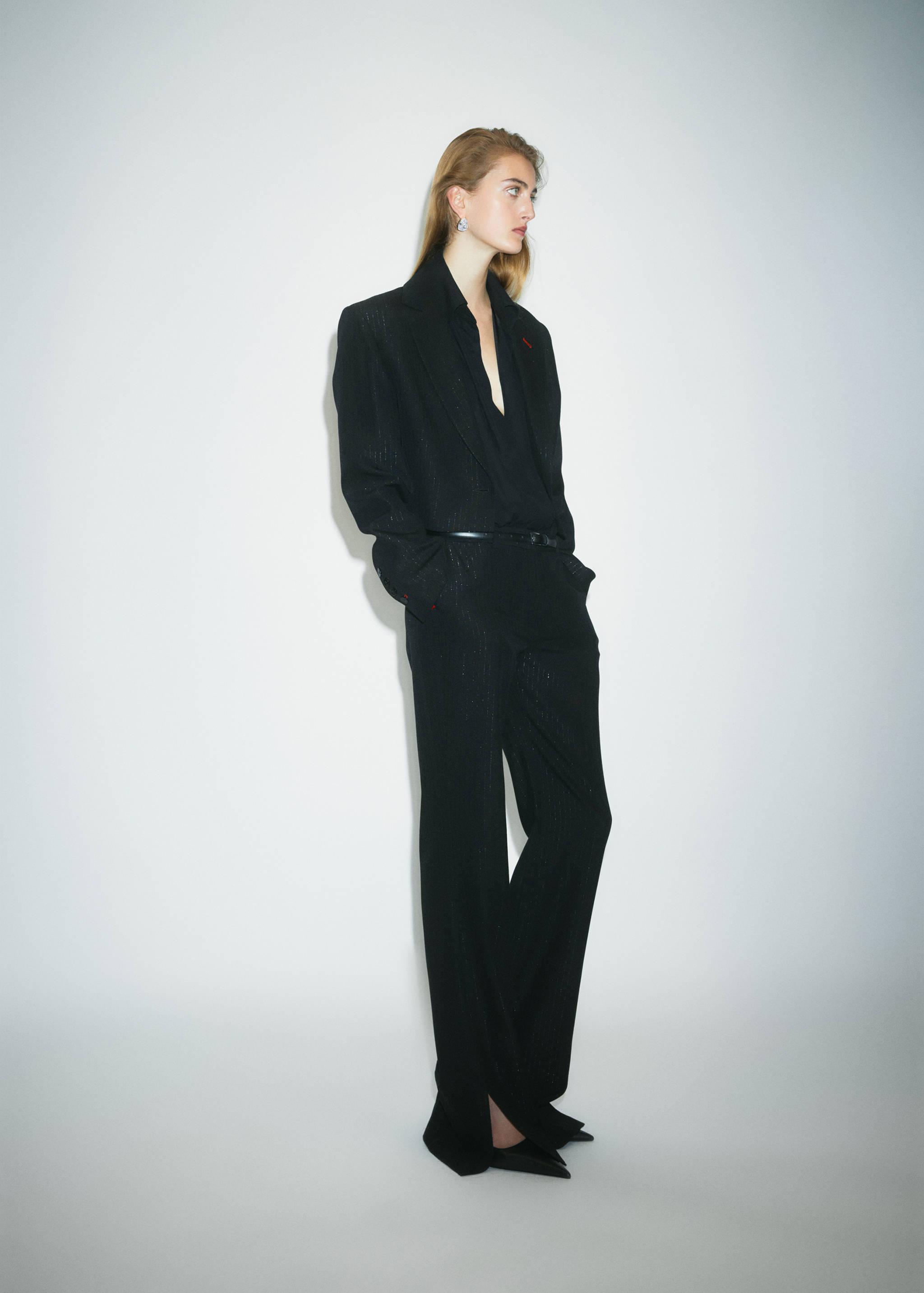 Black pointed shoes worn with a matching black suit and trousers.