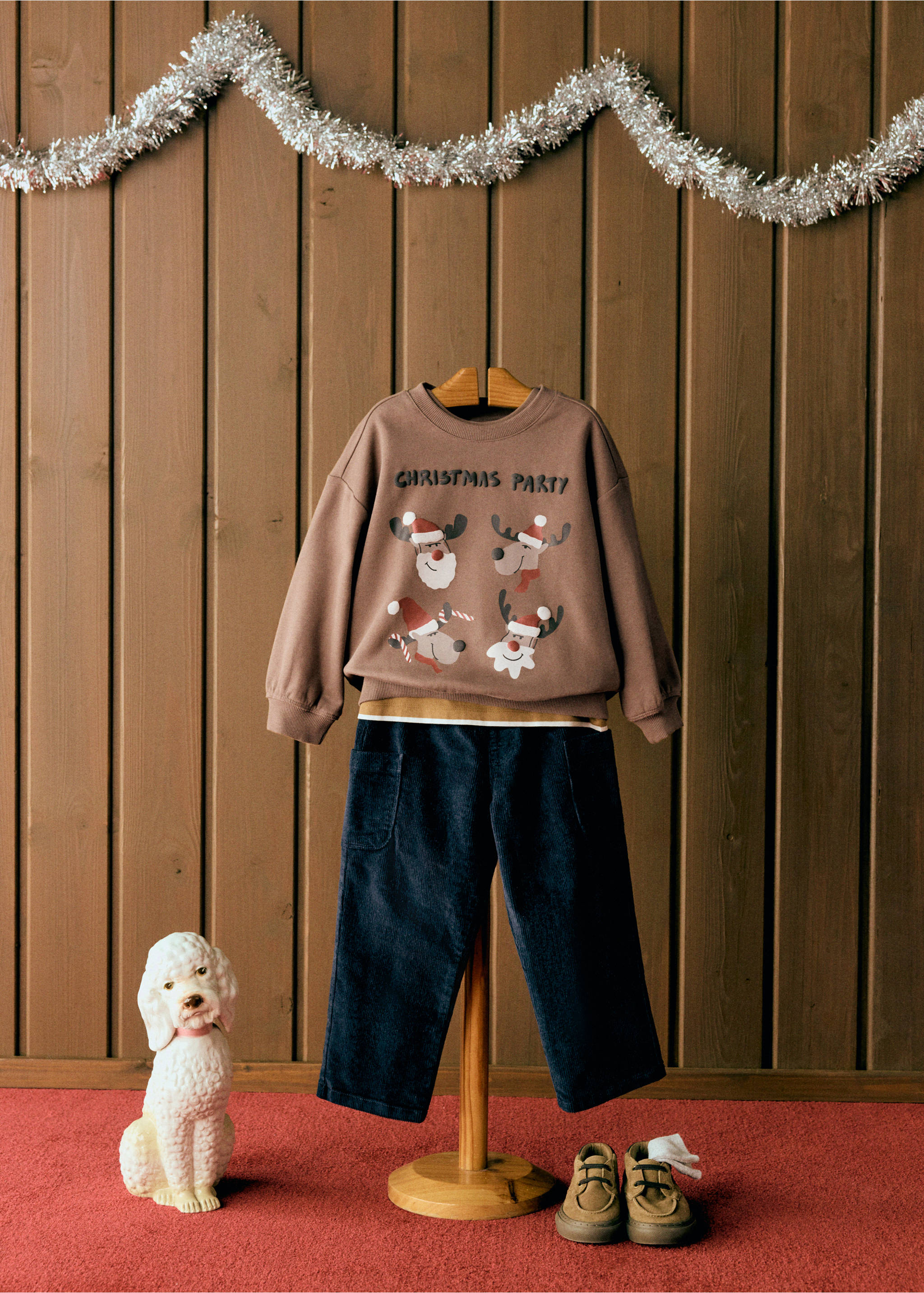 Brown Christmas party sweatshirt with reindeer graphic, styled with navy trousers., Brown. Ref: 37059210-00.