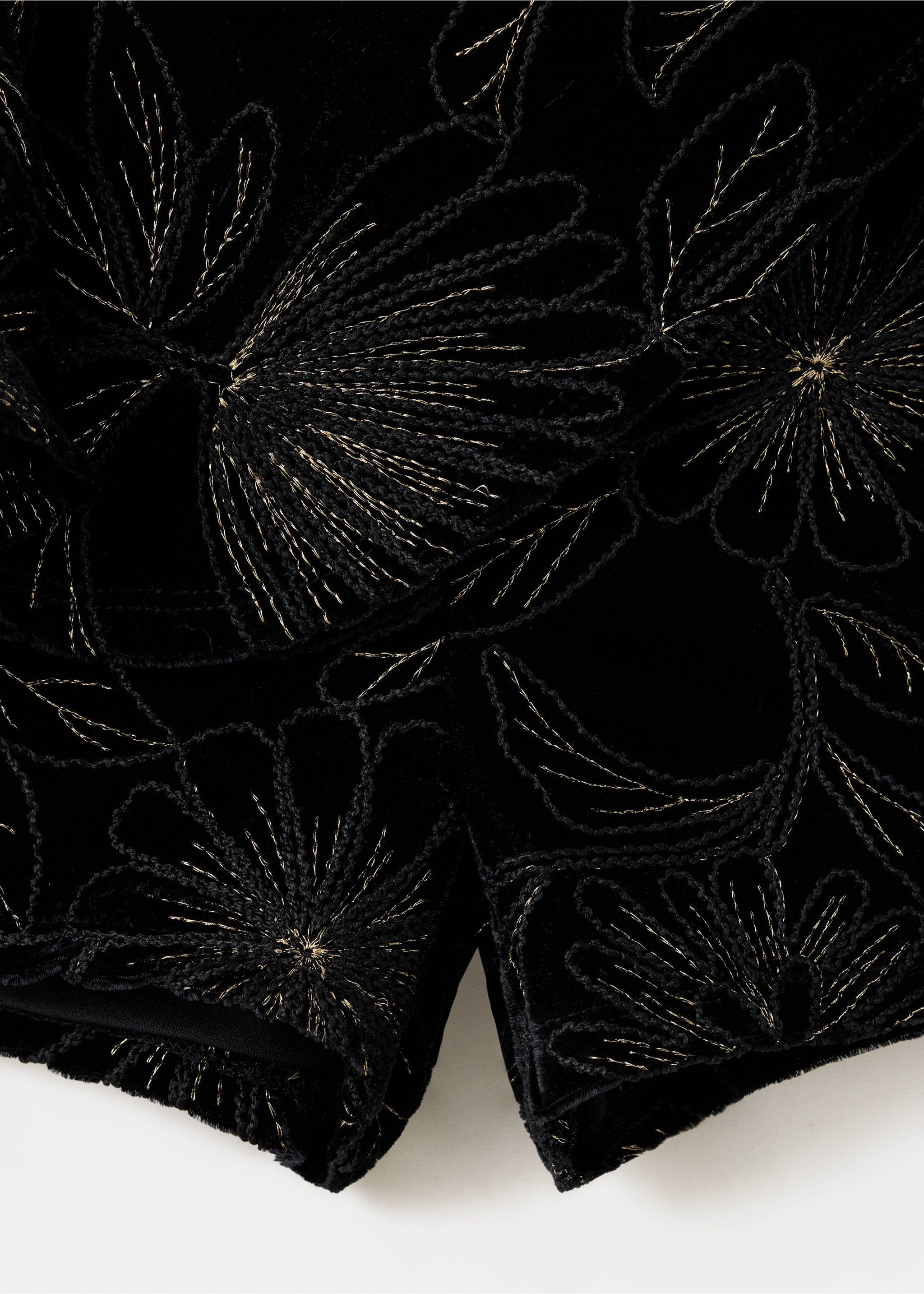 Close-up of black velvet shorts with gold embroidered floral pattern., Black. Ref: 37059212-00.