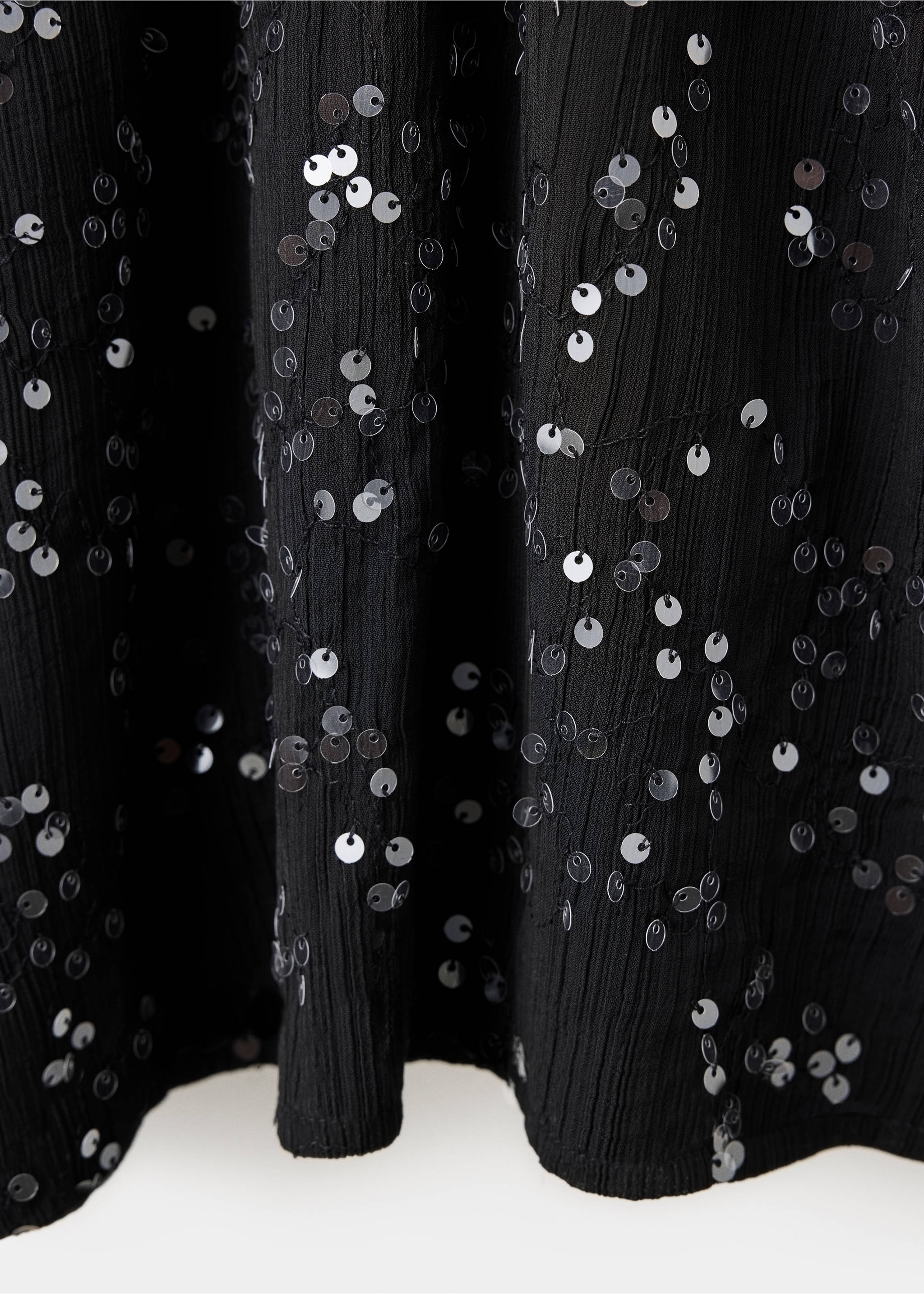 Close-up of a black dress with silver sequin embellishments., Black. Ref: 37059220-00.