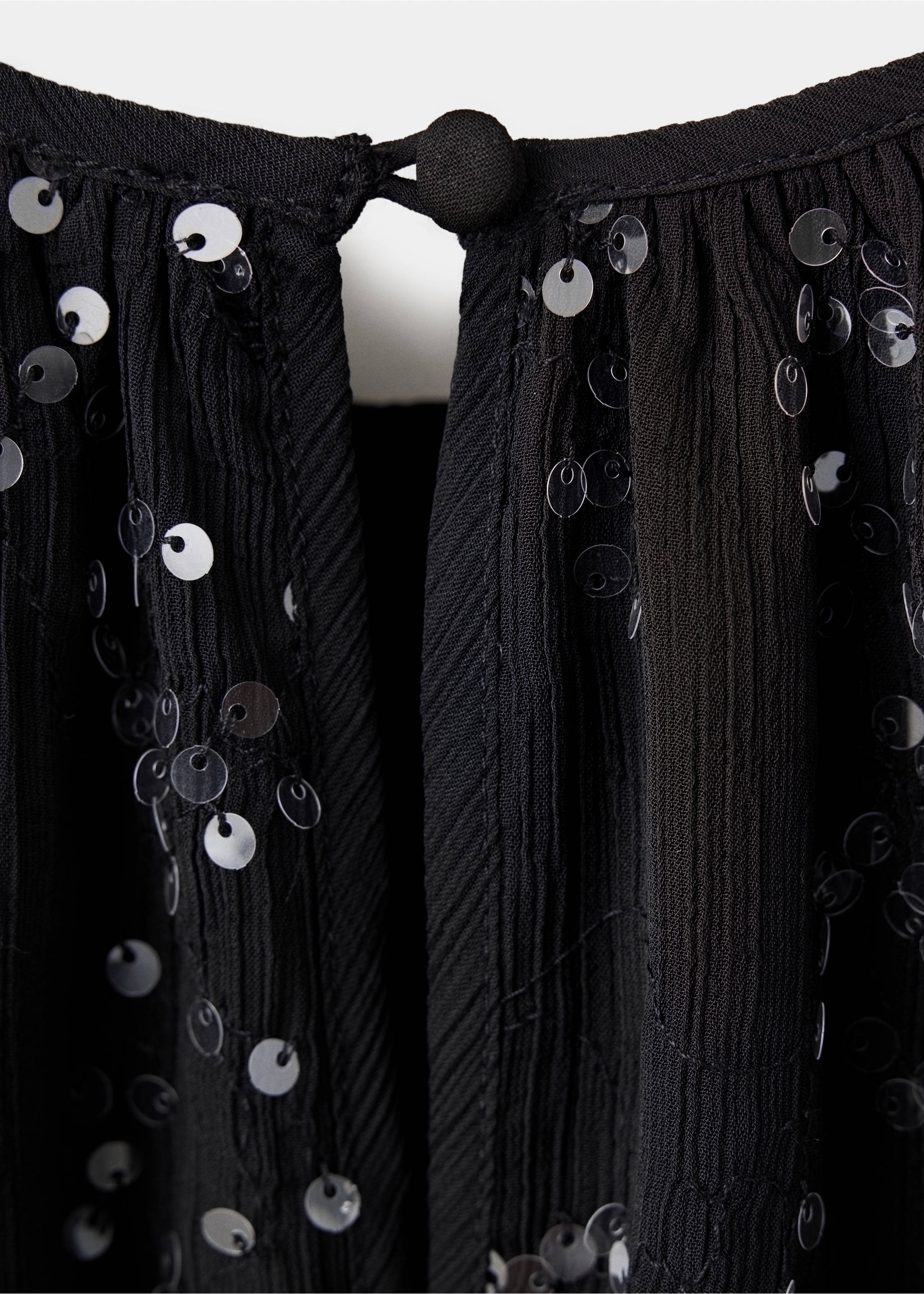 Close-up of black sequinned dress fabric and back keyhole button detail., Black. Ref: 37059220-00.