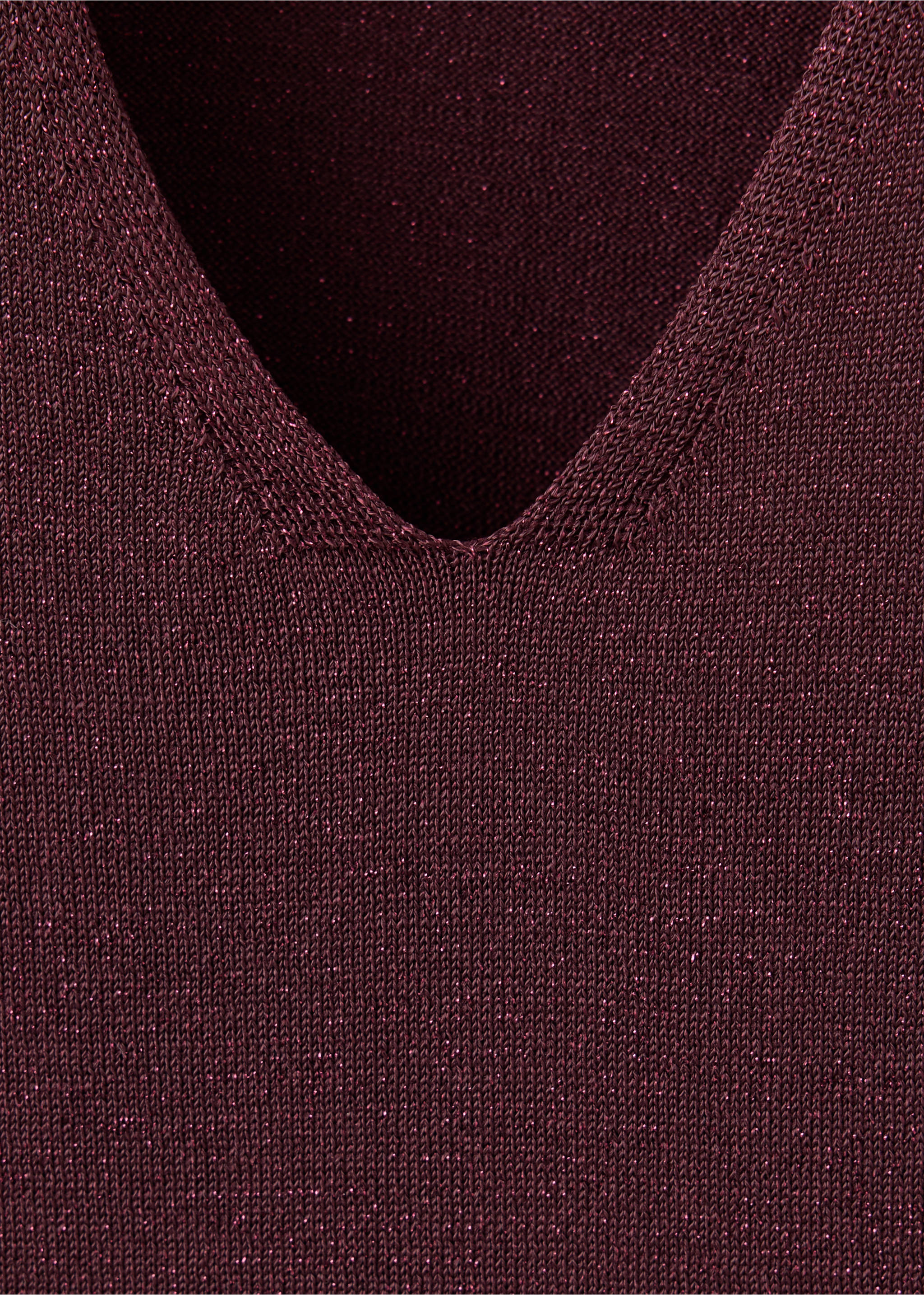 Close-up of the V-neckline on a dark burgundy metallic knit dress., Wine. Ref: 37059227-00.
