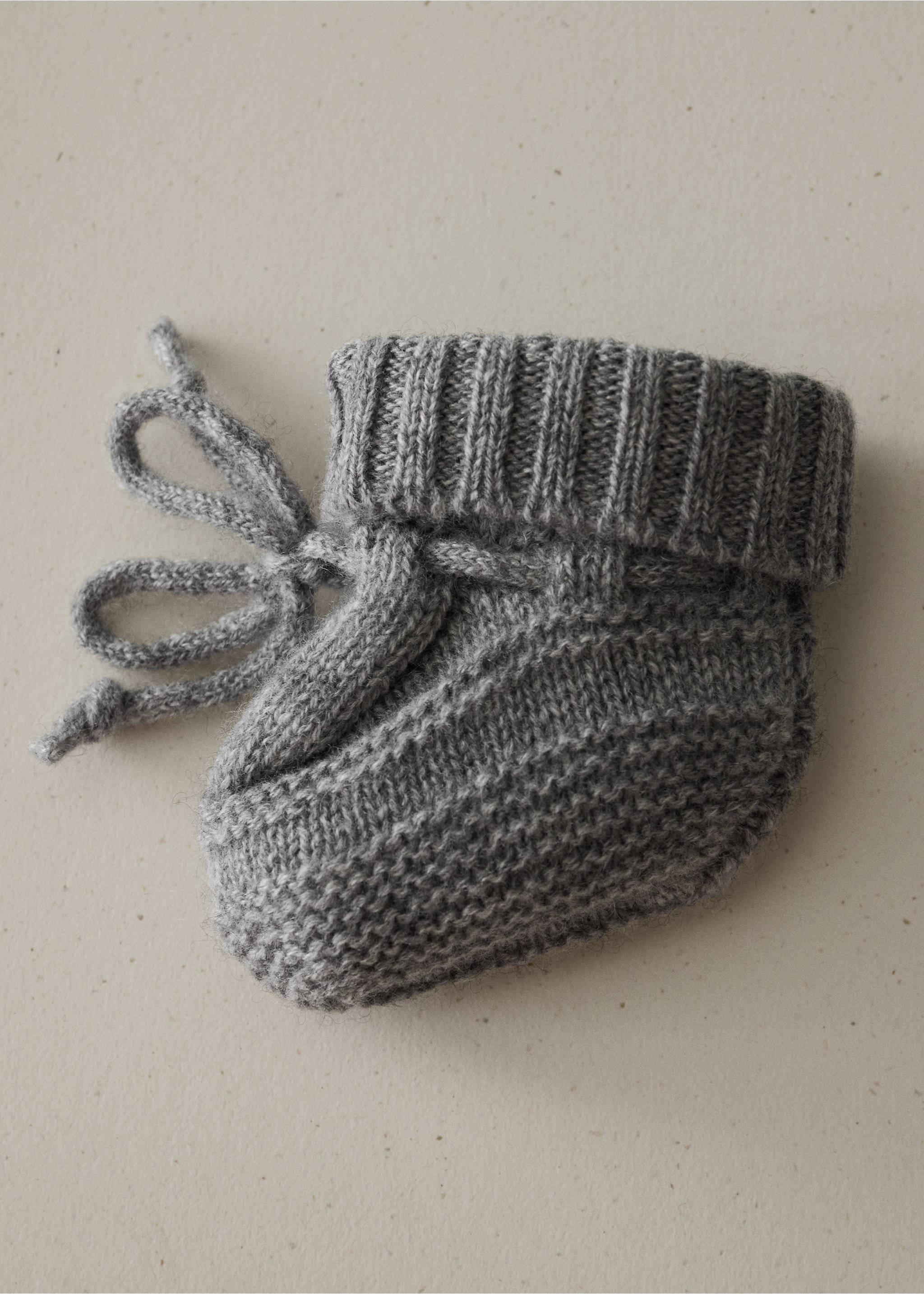 Grey knit baby socks with a ribbed cuff and drawstring bow., Grey. Ref: 37061547-00.