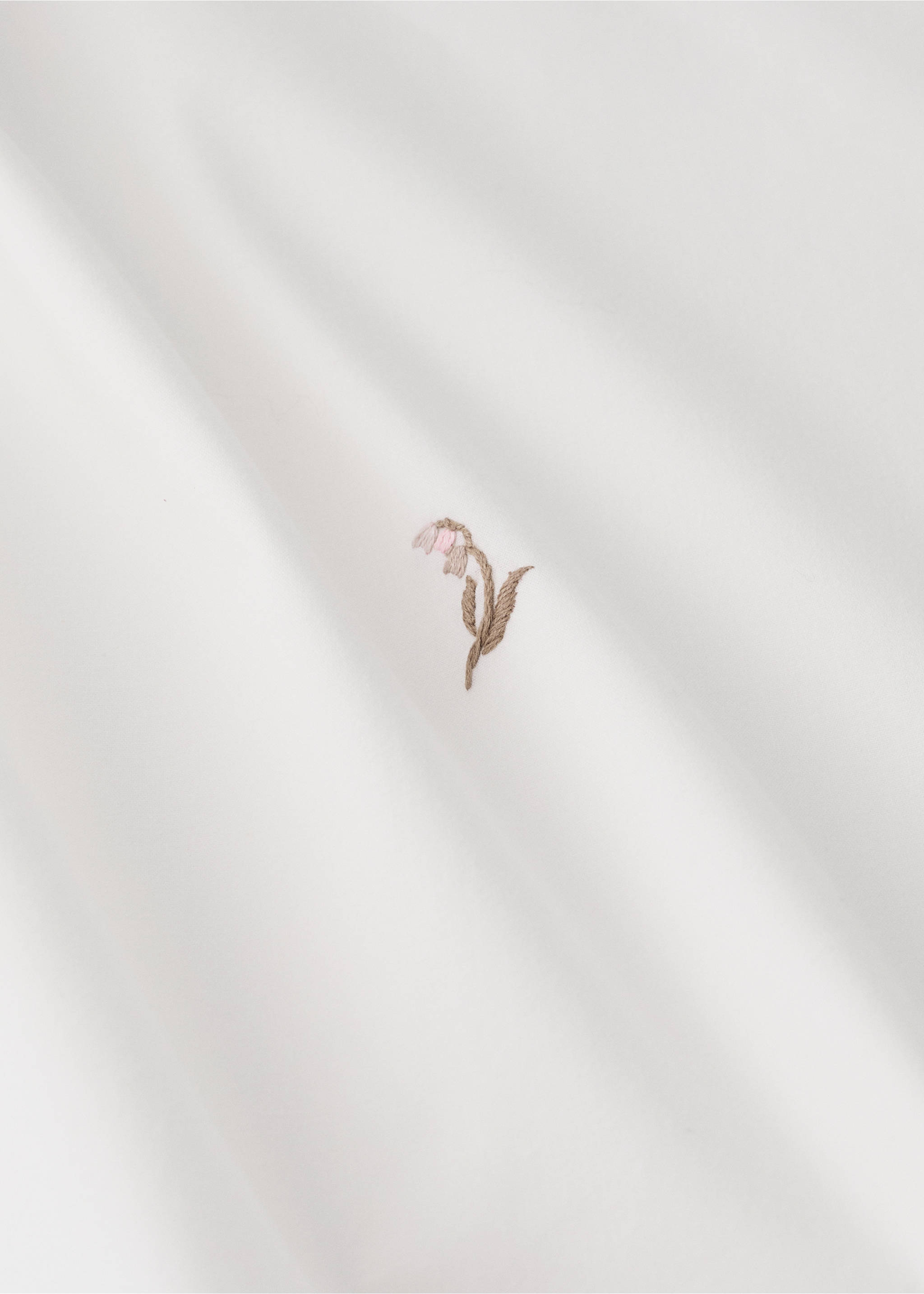 White duvet cover detail with a small embroidered pink and brown flower., Medium Brown. Ref: 37062559-00.