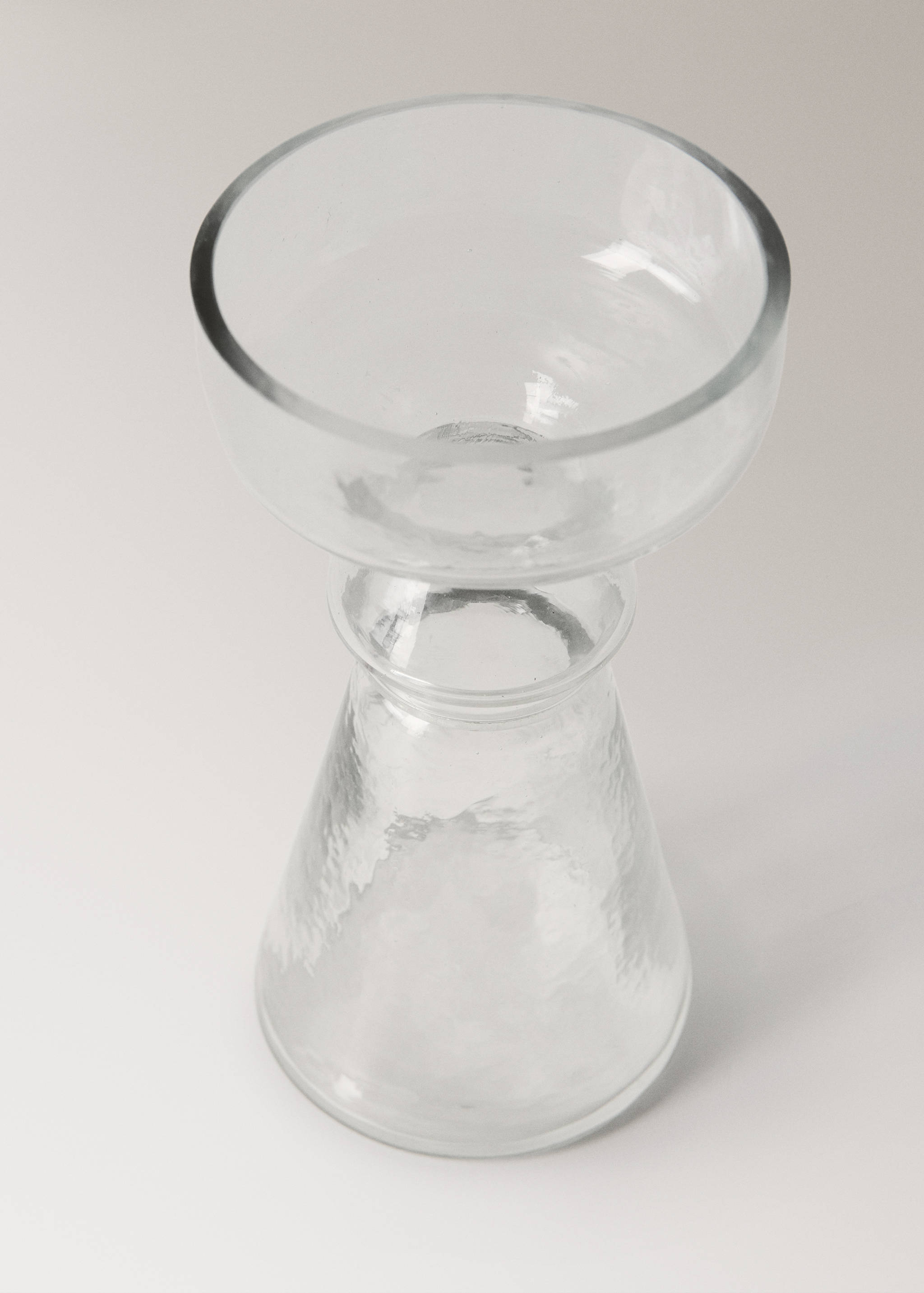 Clear glass candle holder with a textured base and wide upper bowl.