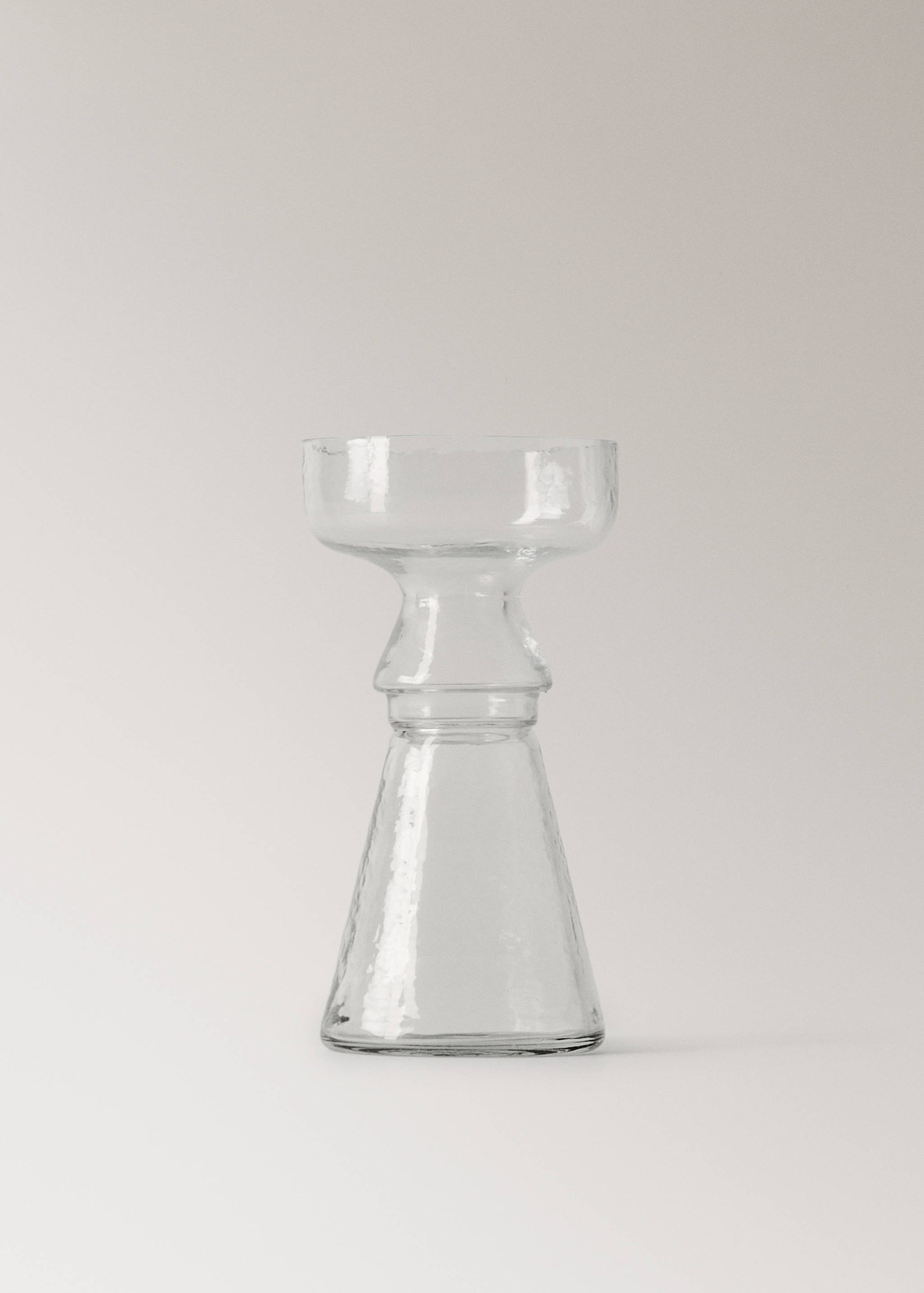 Clear glass candleholder with a flared base and wide top.